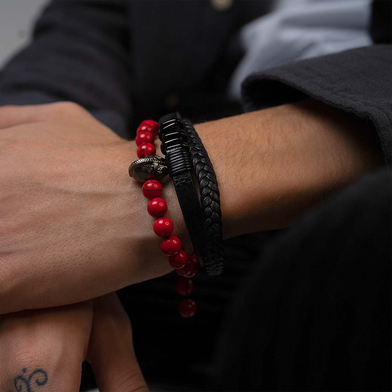 Bracelet with red beads and helmet pendant