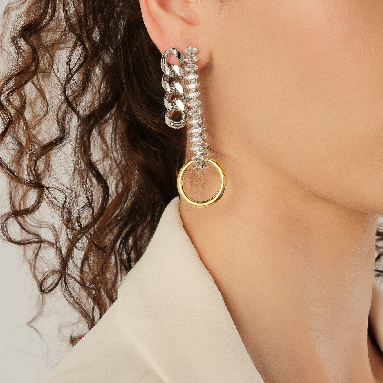 Silver asymmetric earrings with a golden circle and crystals