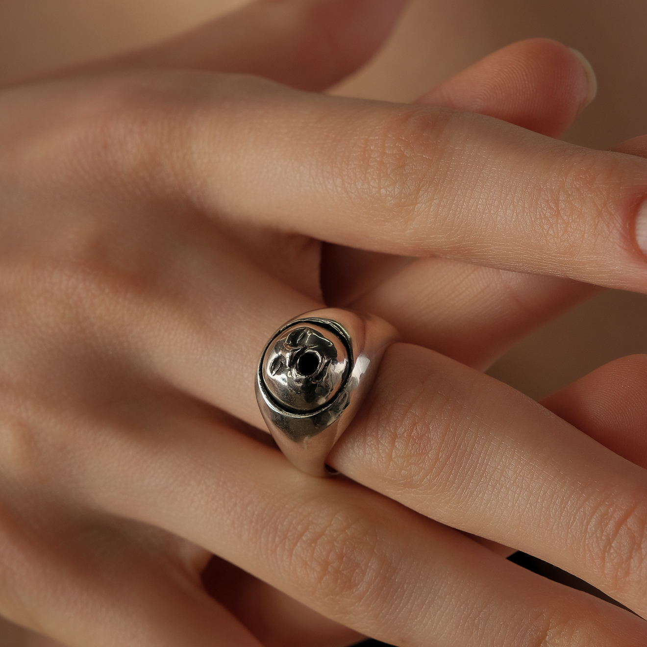 Silver ring with a face
