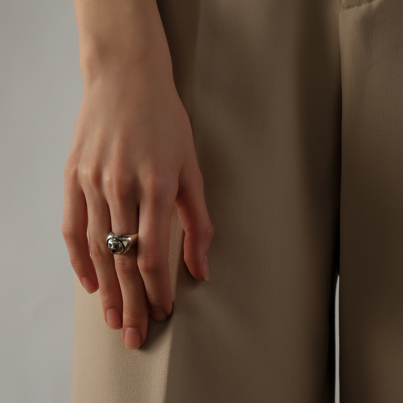 Silver ring with a face