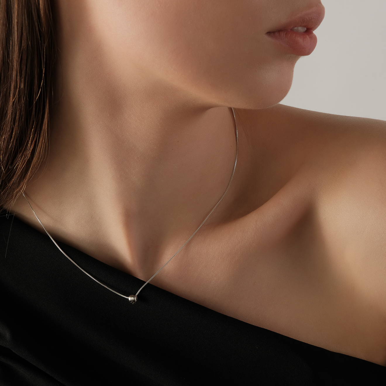 Silver chain with skull and axe pendant