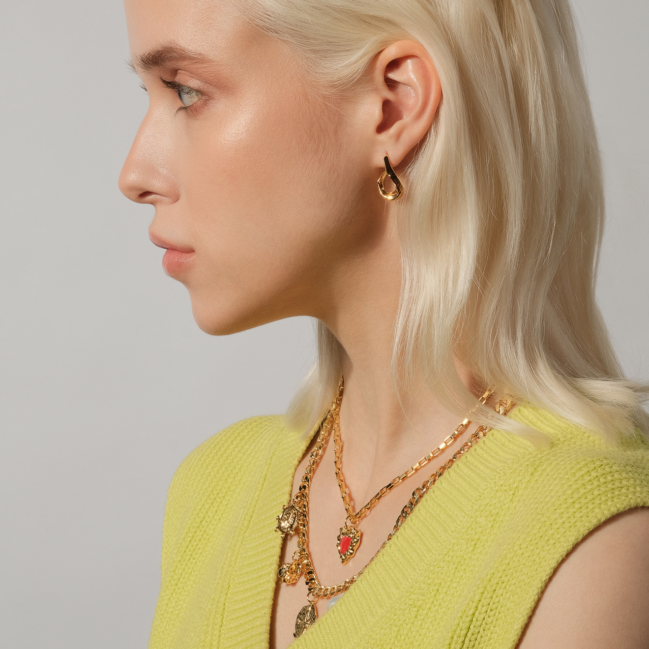 necklace with medallions and a red heart