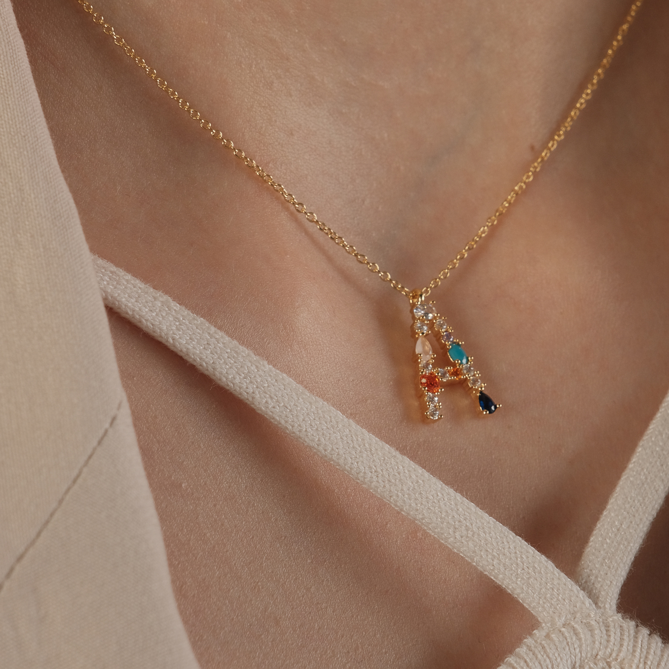 pendant with the letter A made of colored crystals