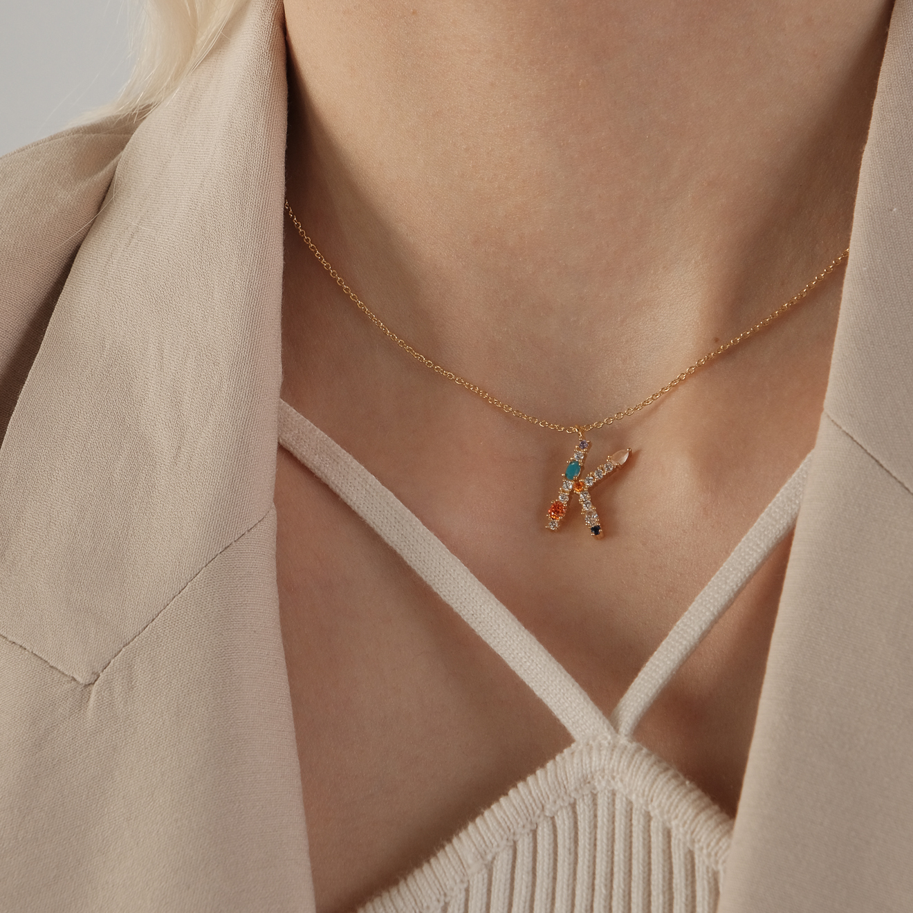 pendant with the letter K made of colored crystals