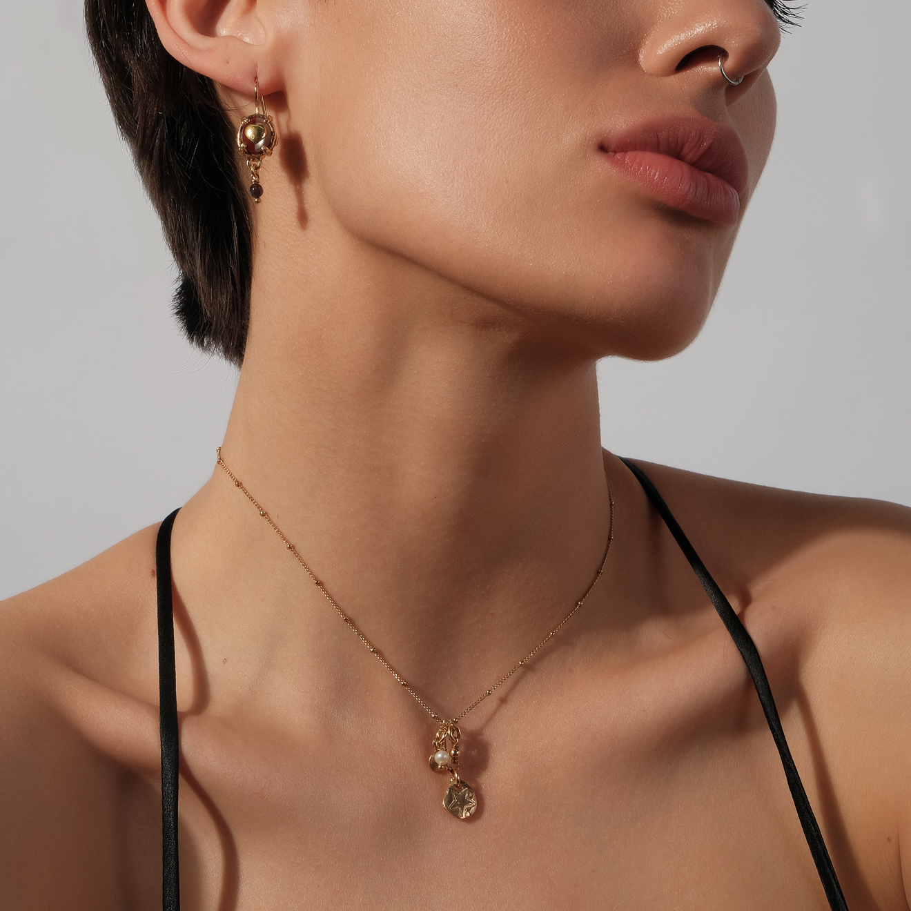 Gold-plated necklace with textured pendant medallions and pearls