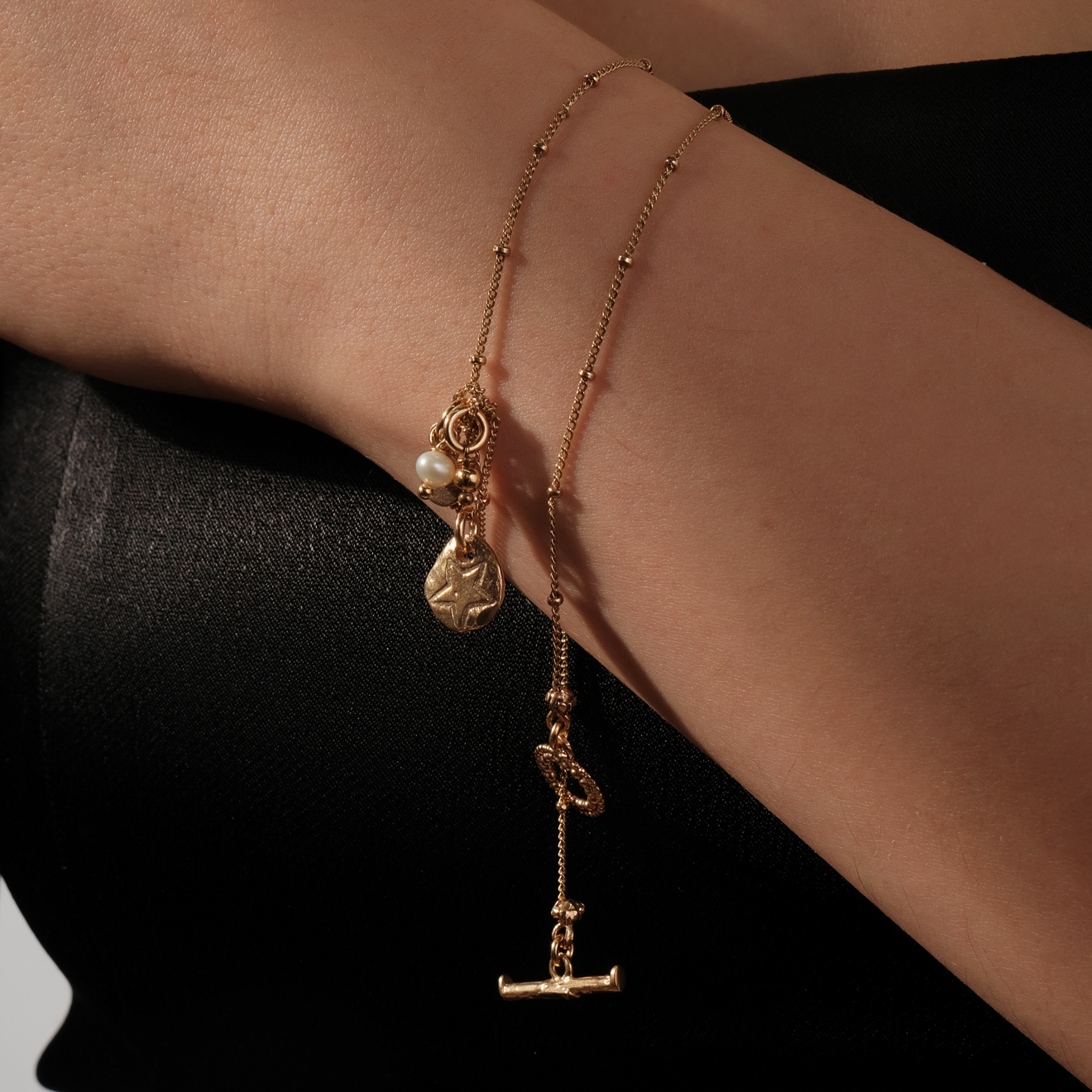 Gold-plated necklace with textured pendant medallions and pearls