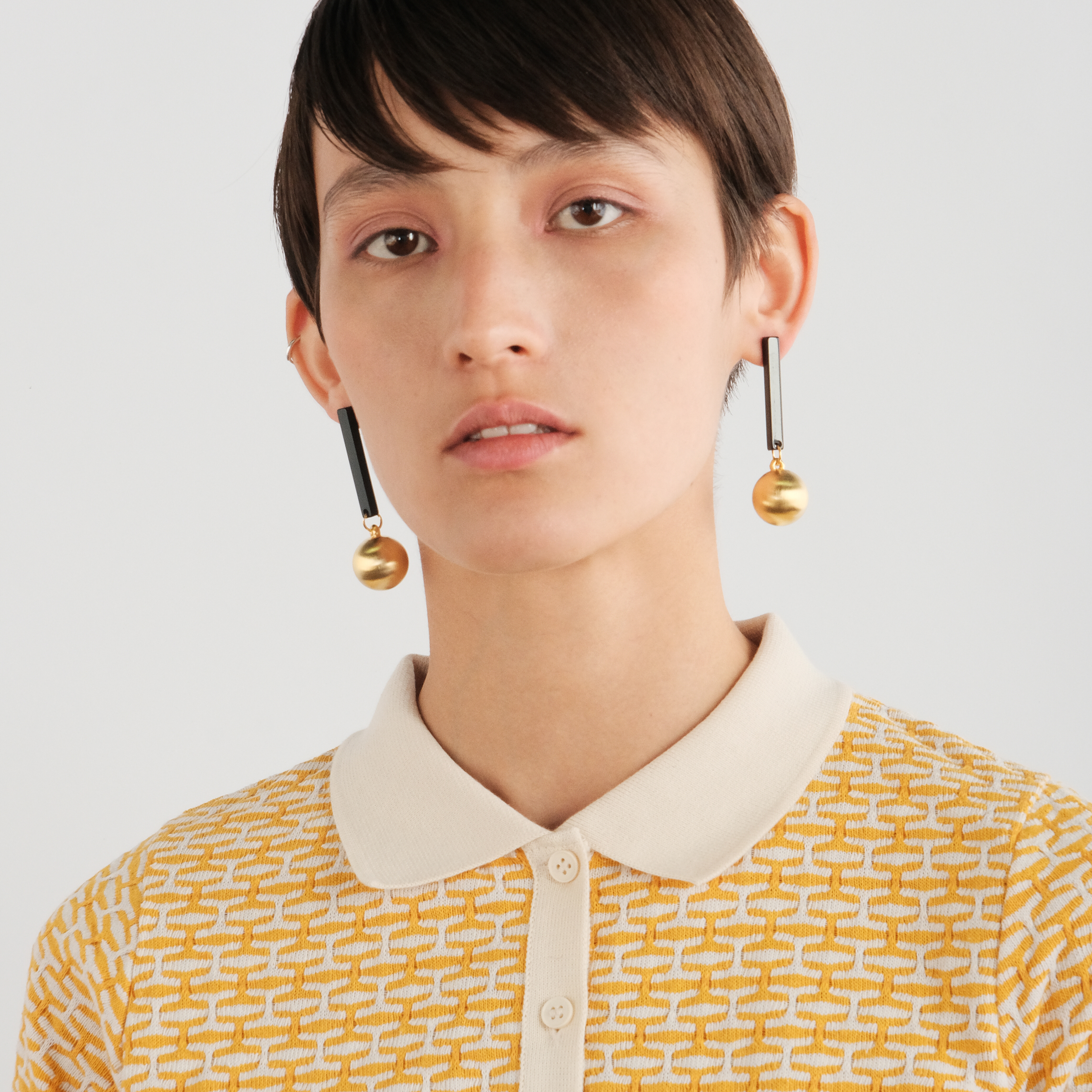 Black earrings with matte golden balls