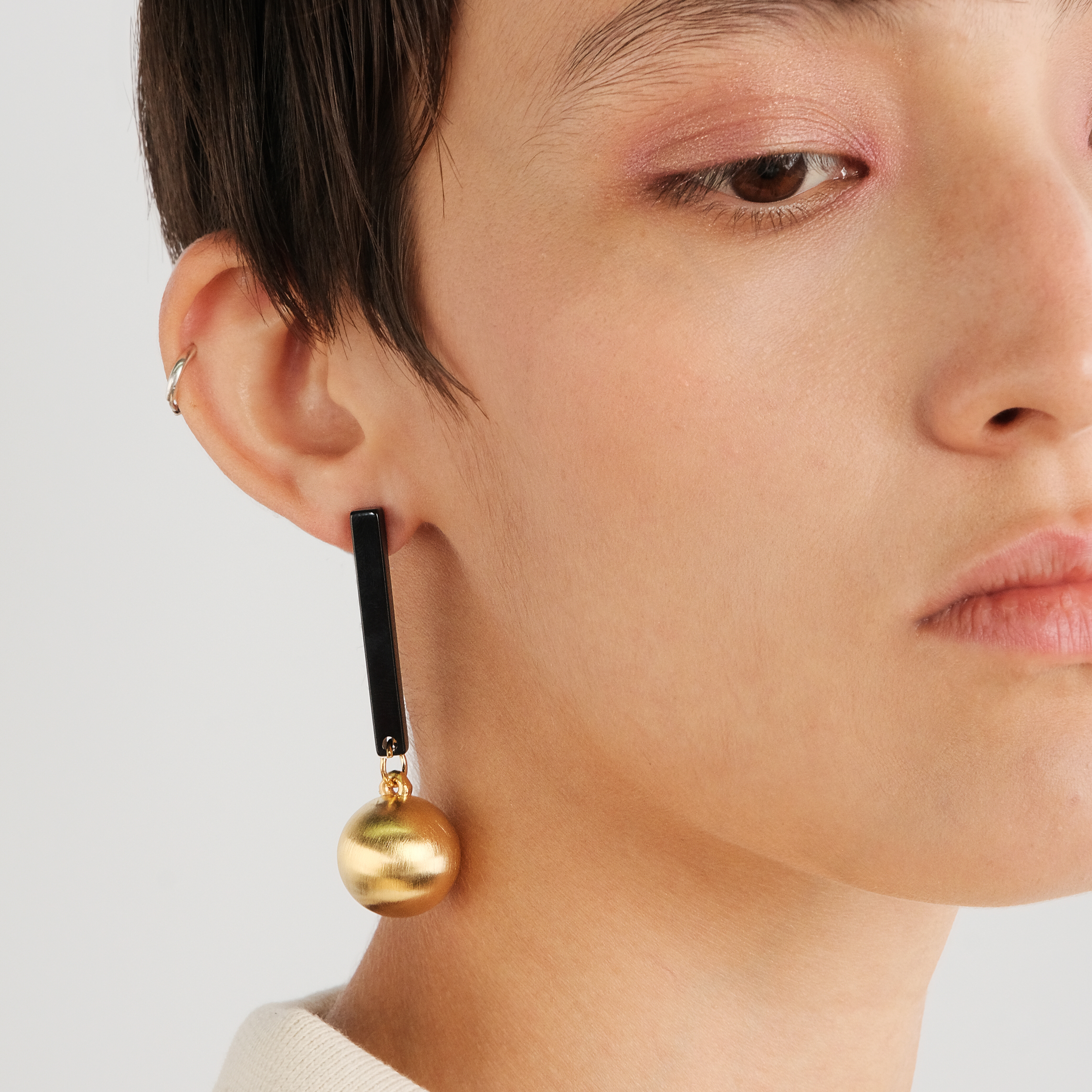 Black earrings with matte golden balls