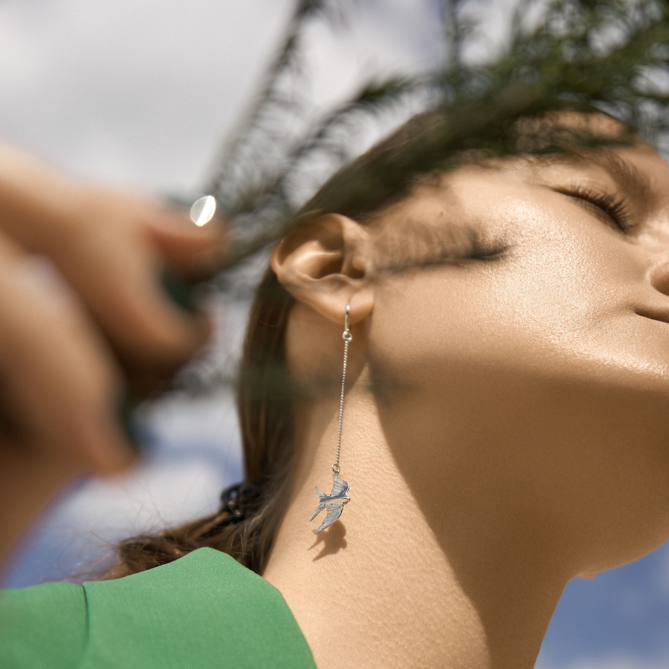 Earrings on chains with small swallows