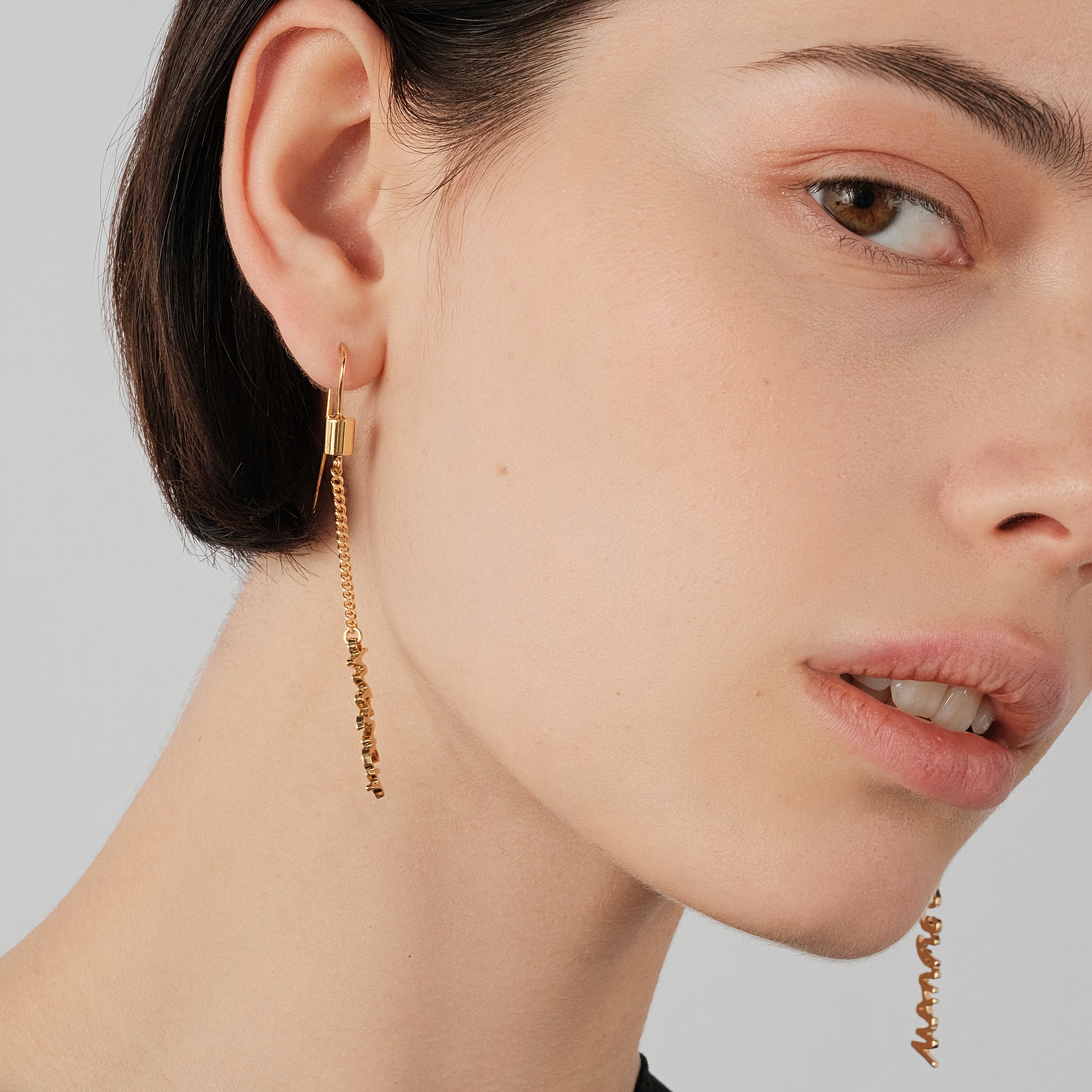 Gold-plated long asymmetrical earrings with inscription