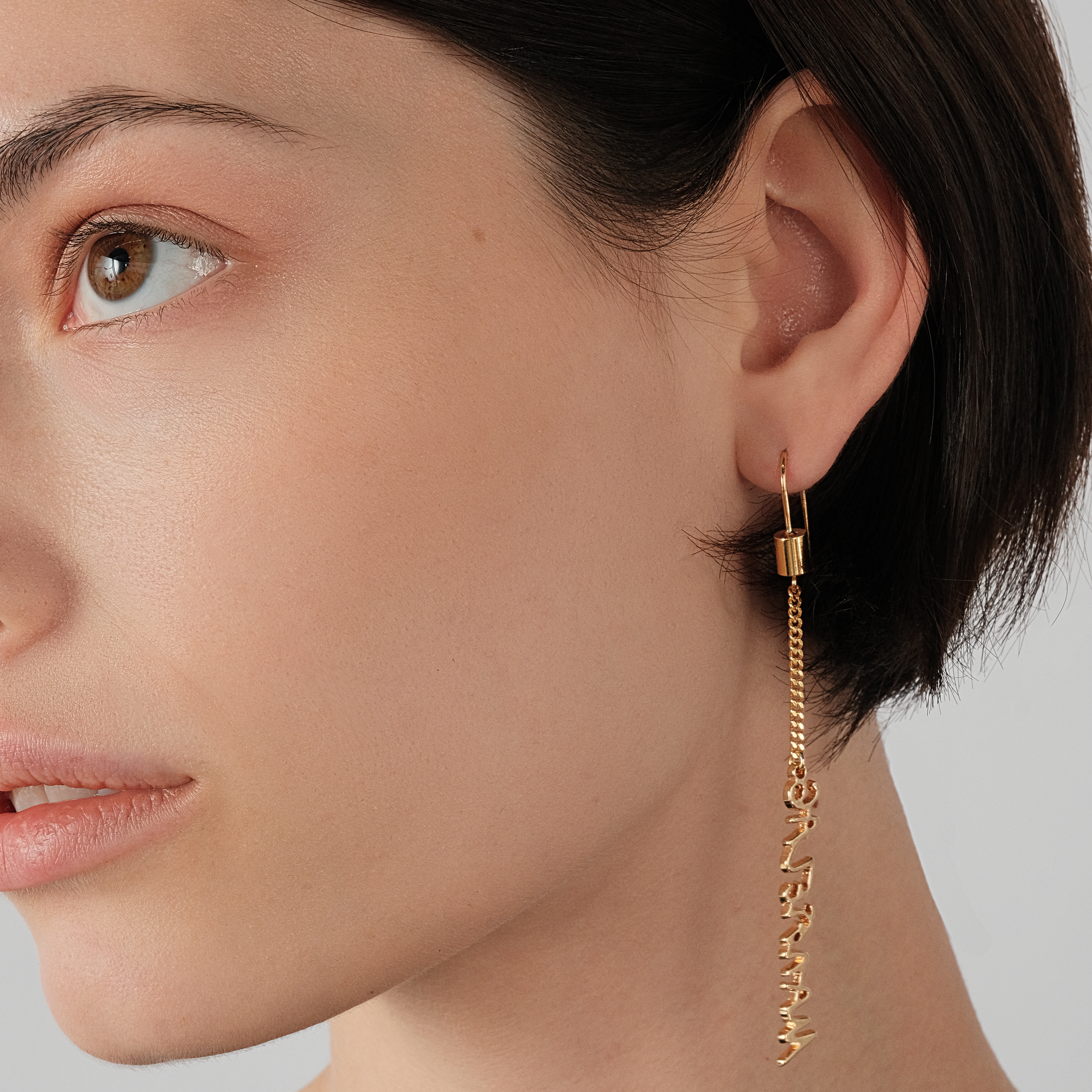 Gold-plated long asymmetrical earrings with inscription