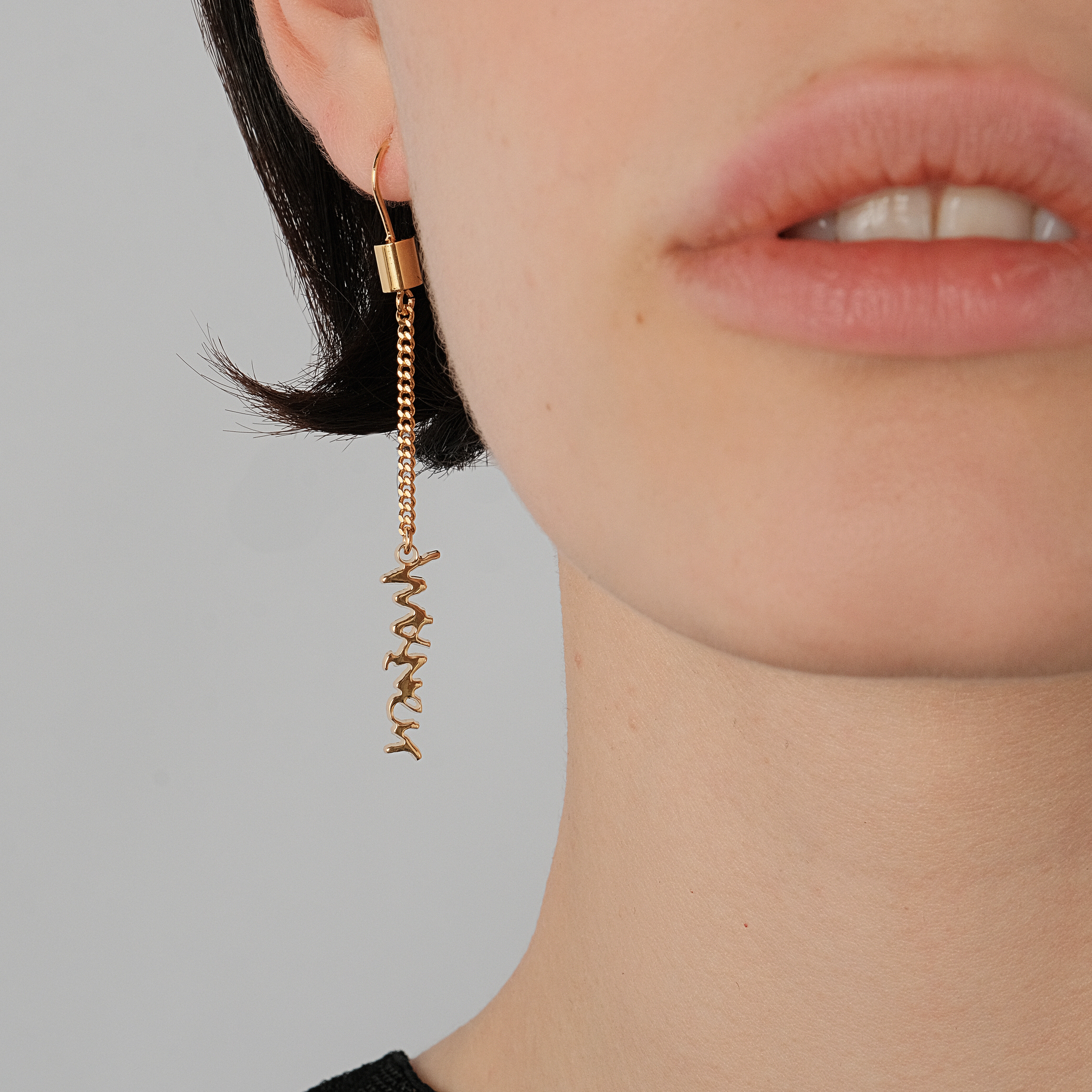 Gold-plated long asymmetrical earrings with inscription