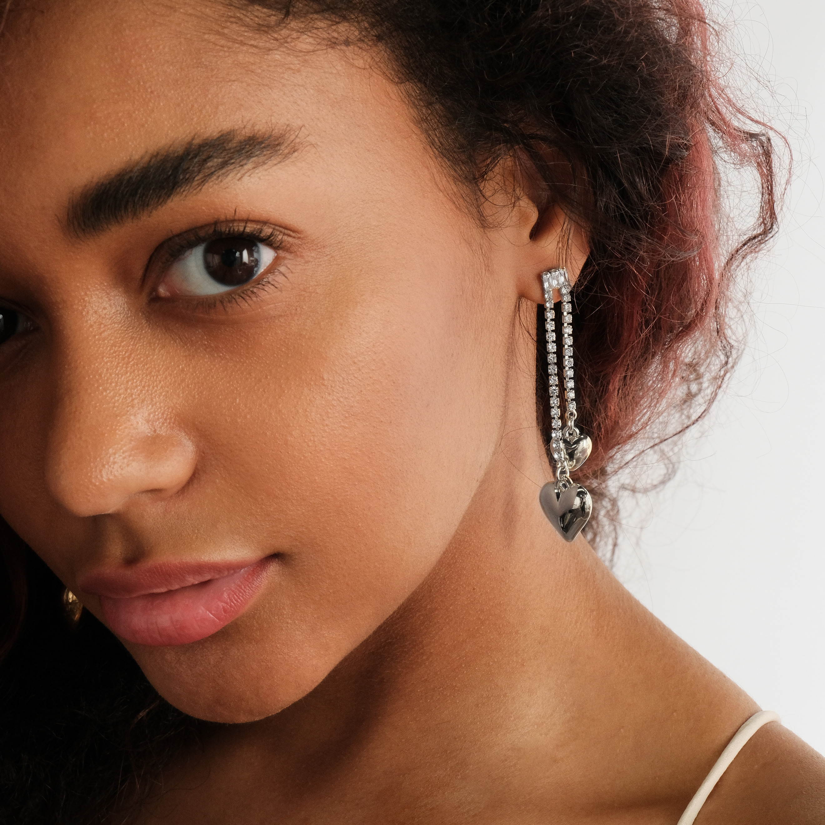 asymmetric earrings with crystals and hearts