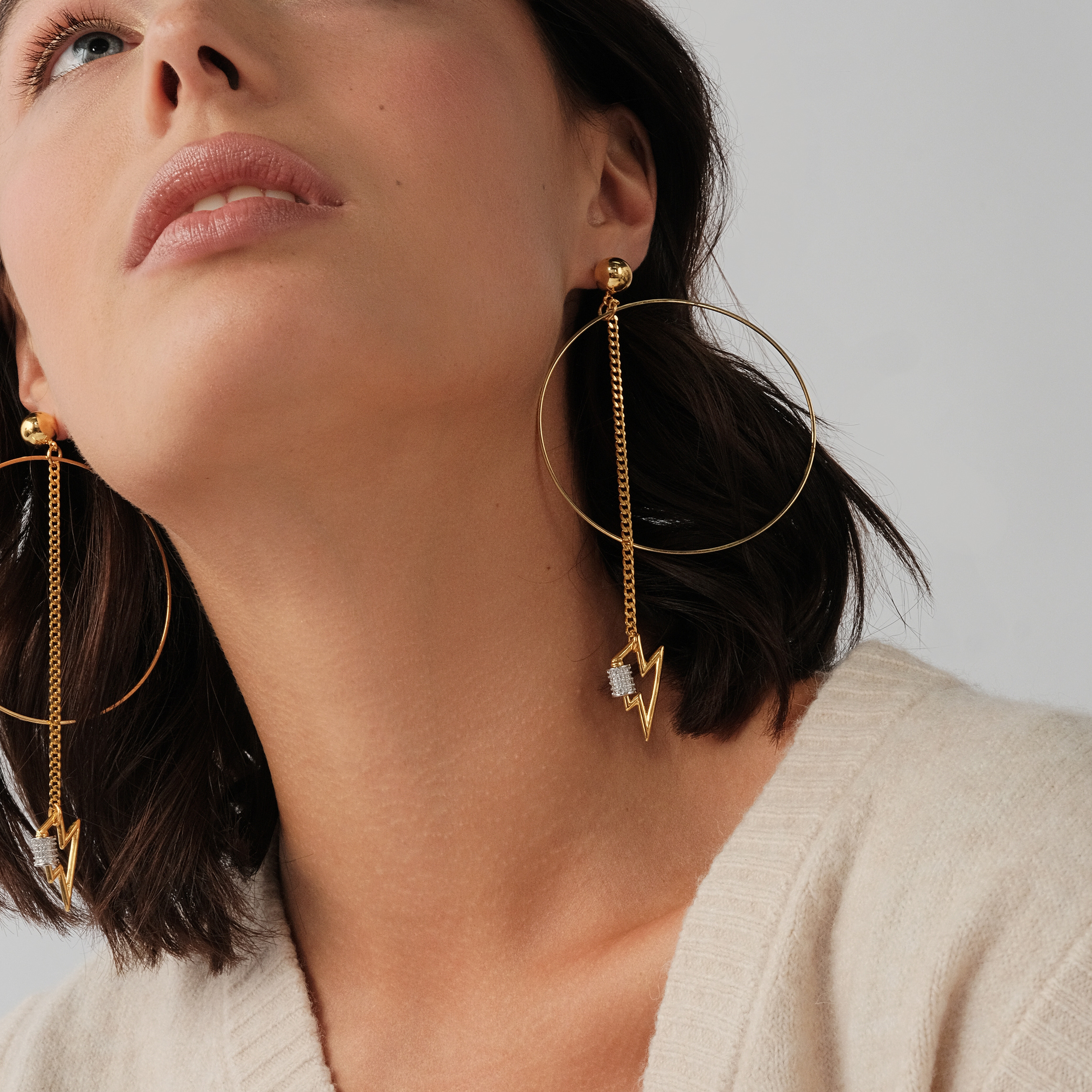 earrings with a circle and a zipper pendant