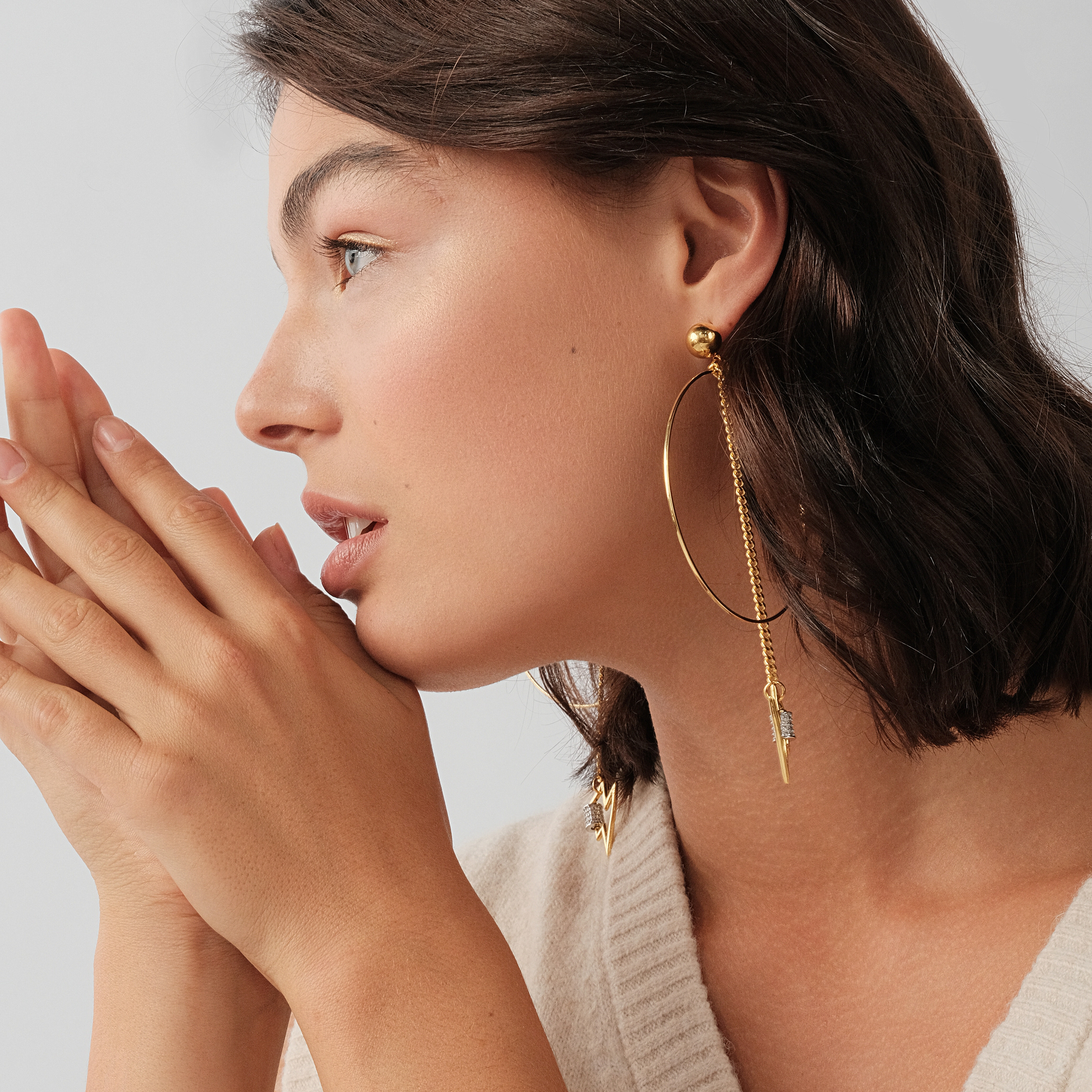 earrings with a circle and a zipper pendant