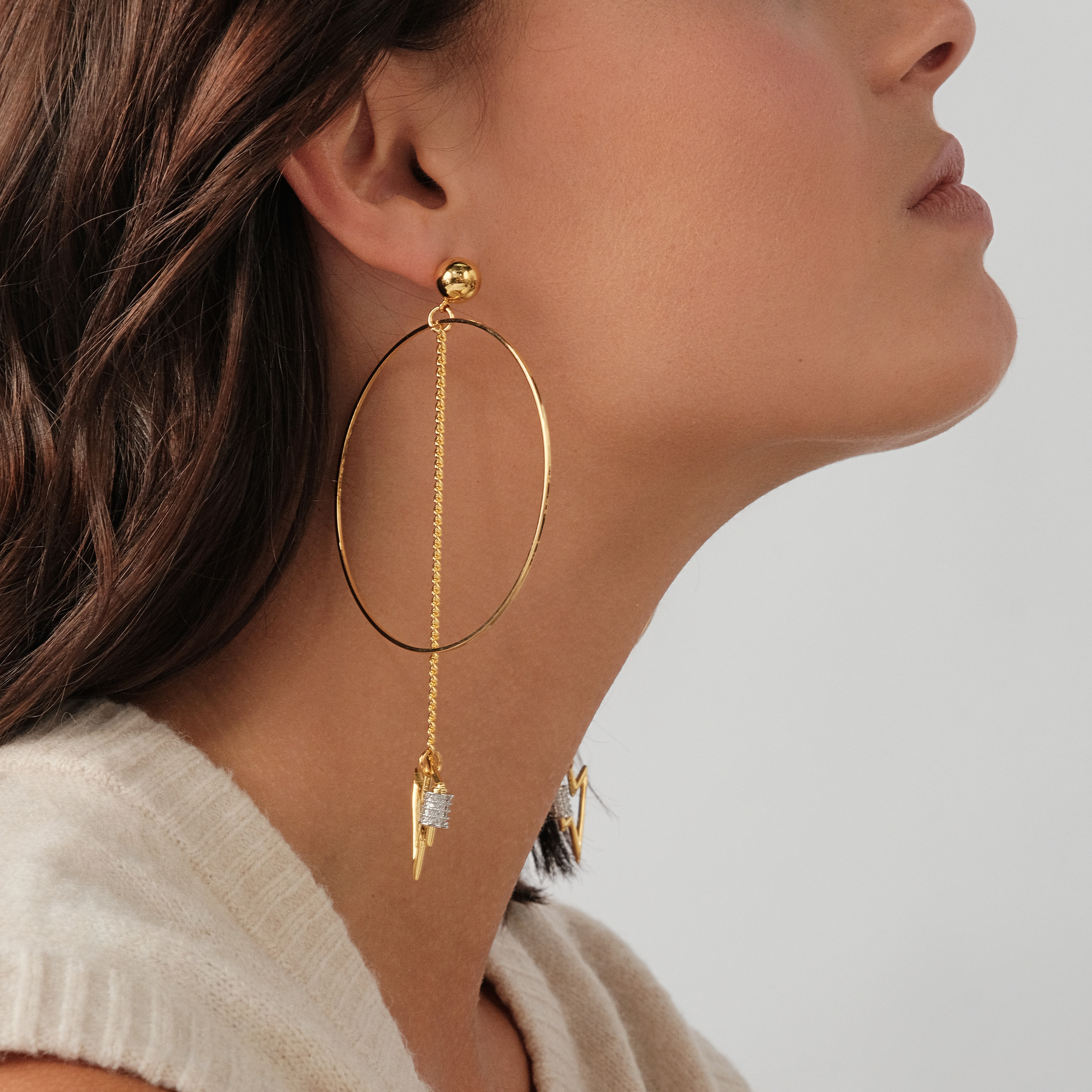 earrings with a circle and a zipper pendant