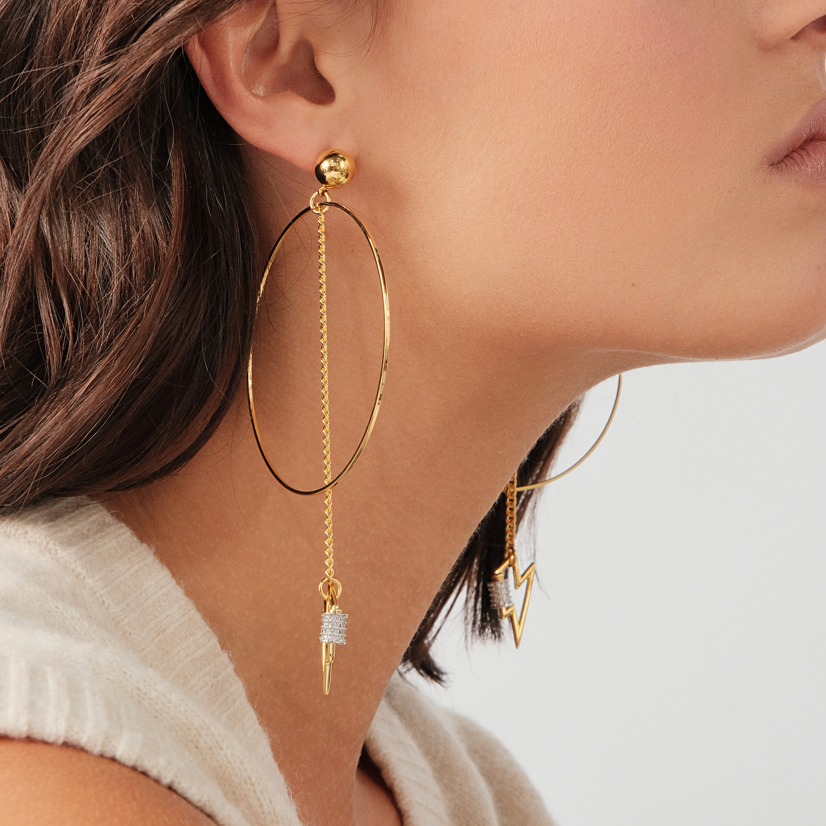earrings with a circle and a zipper pendant