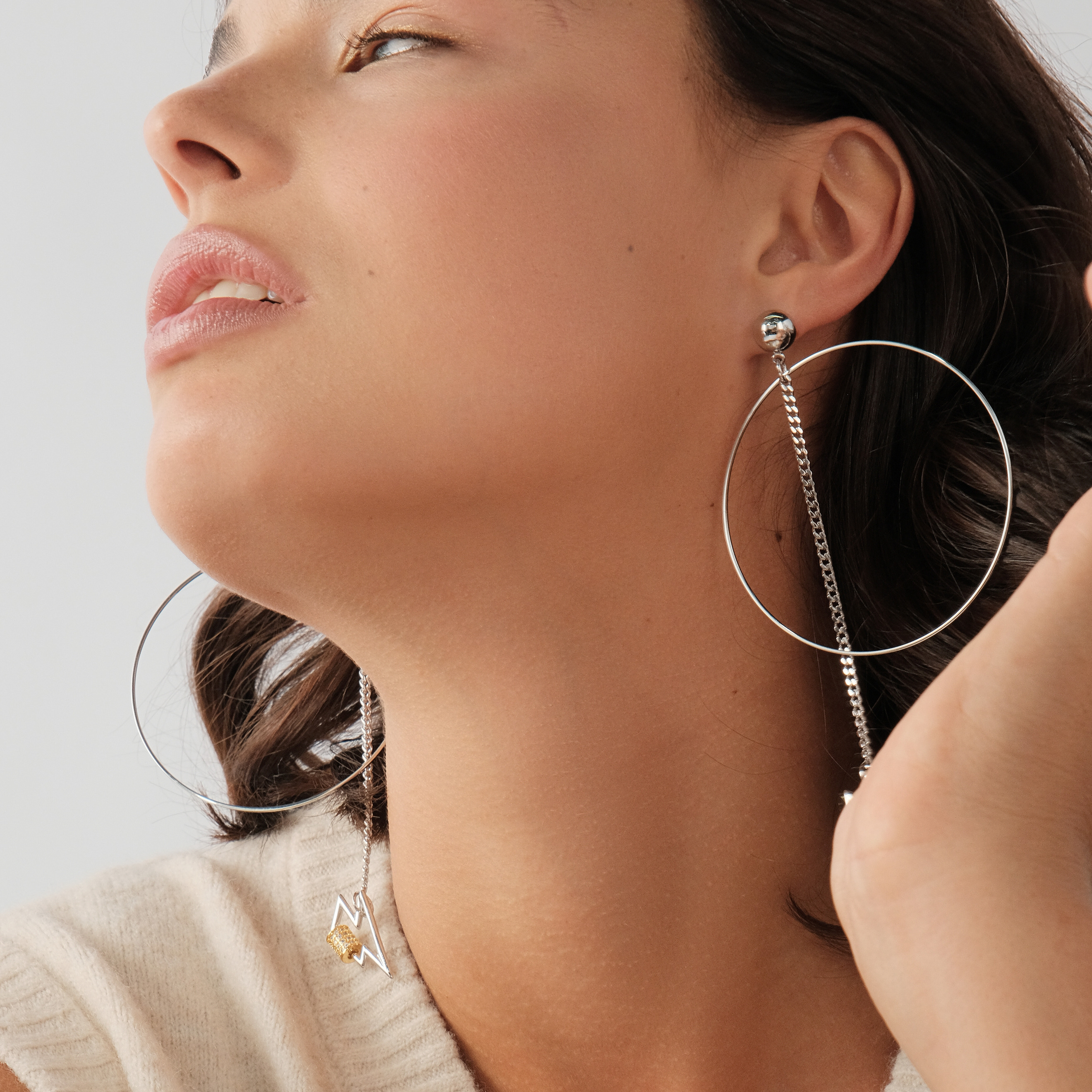 earrings with a circle and a zipper pendant