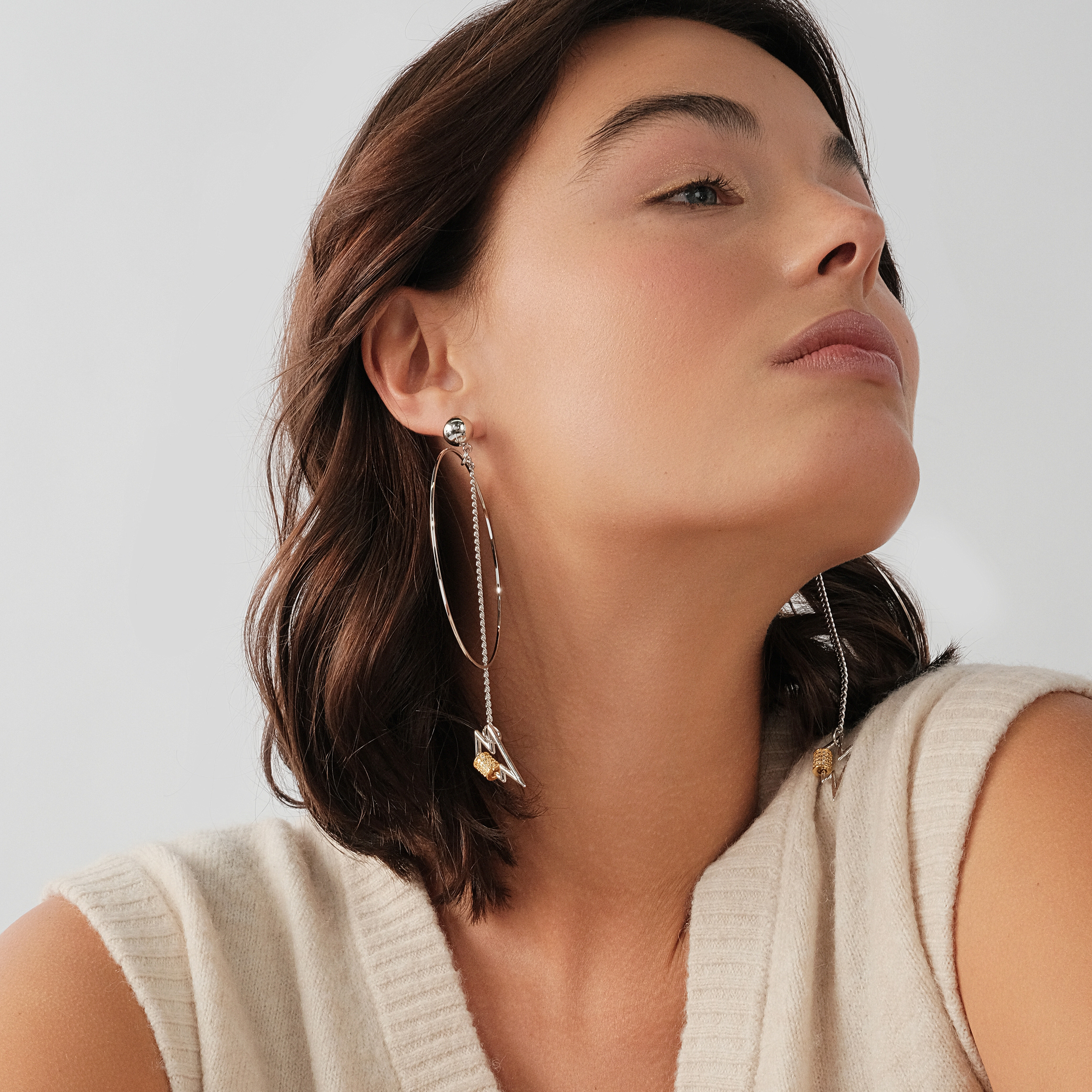 earrings with a circle and a zipper pendant