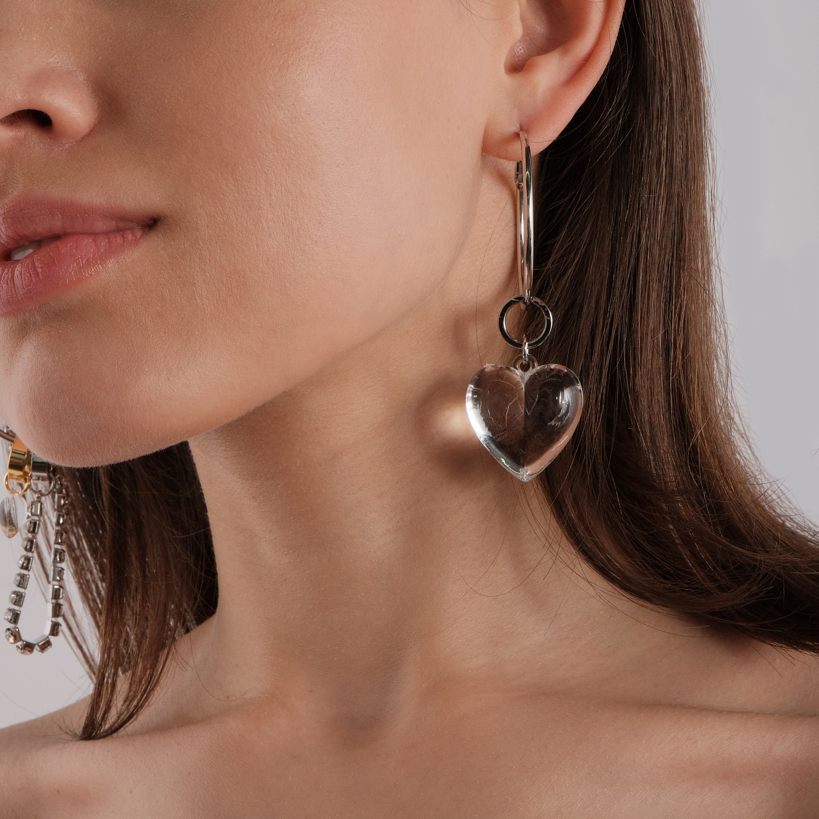 asymmetric earrings with a heart and a crystal pendant