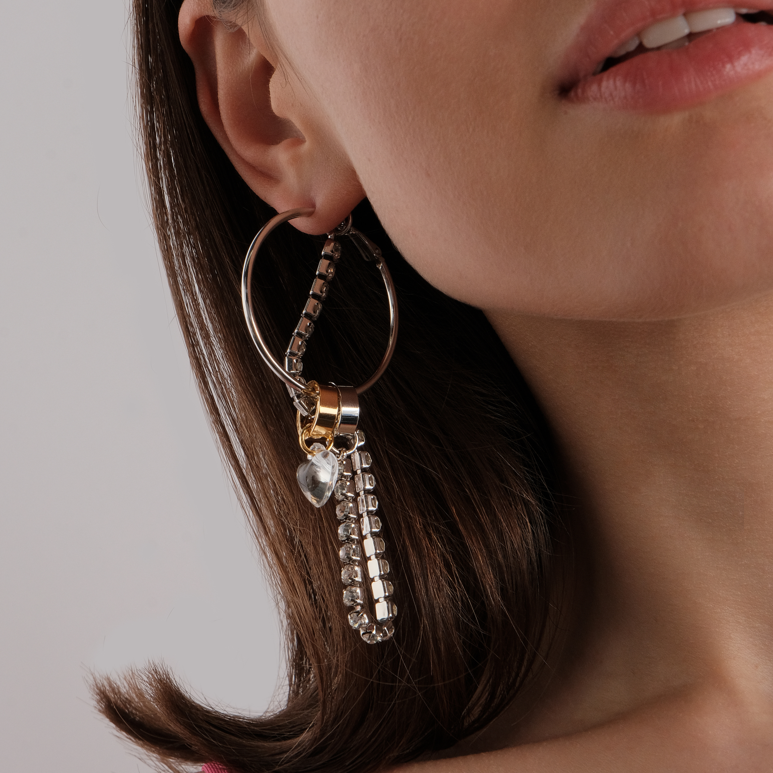asymmetric earrings with a heart and a crystal pendant