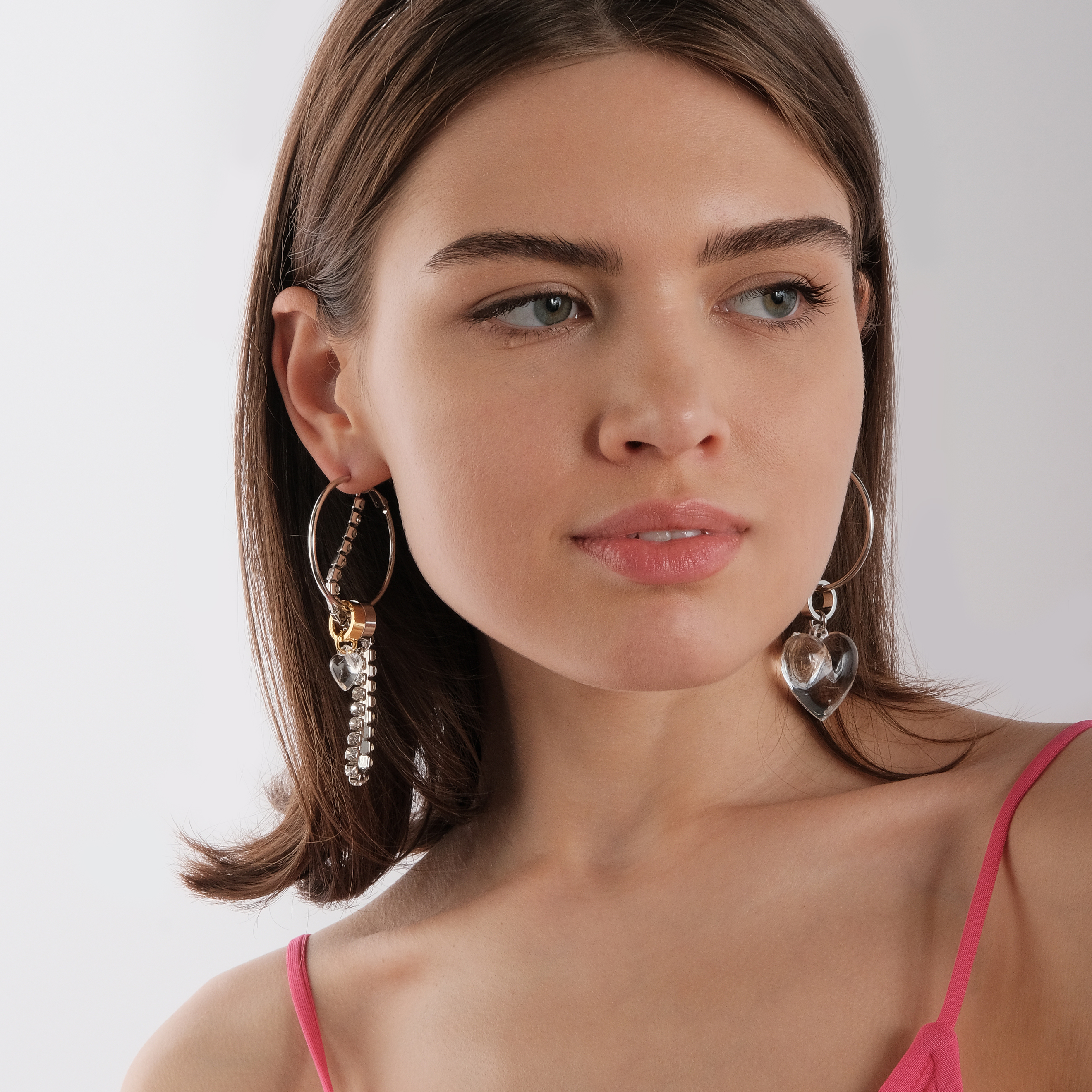 asymmetric earrings with a heart and a crystal pendant