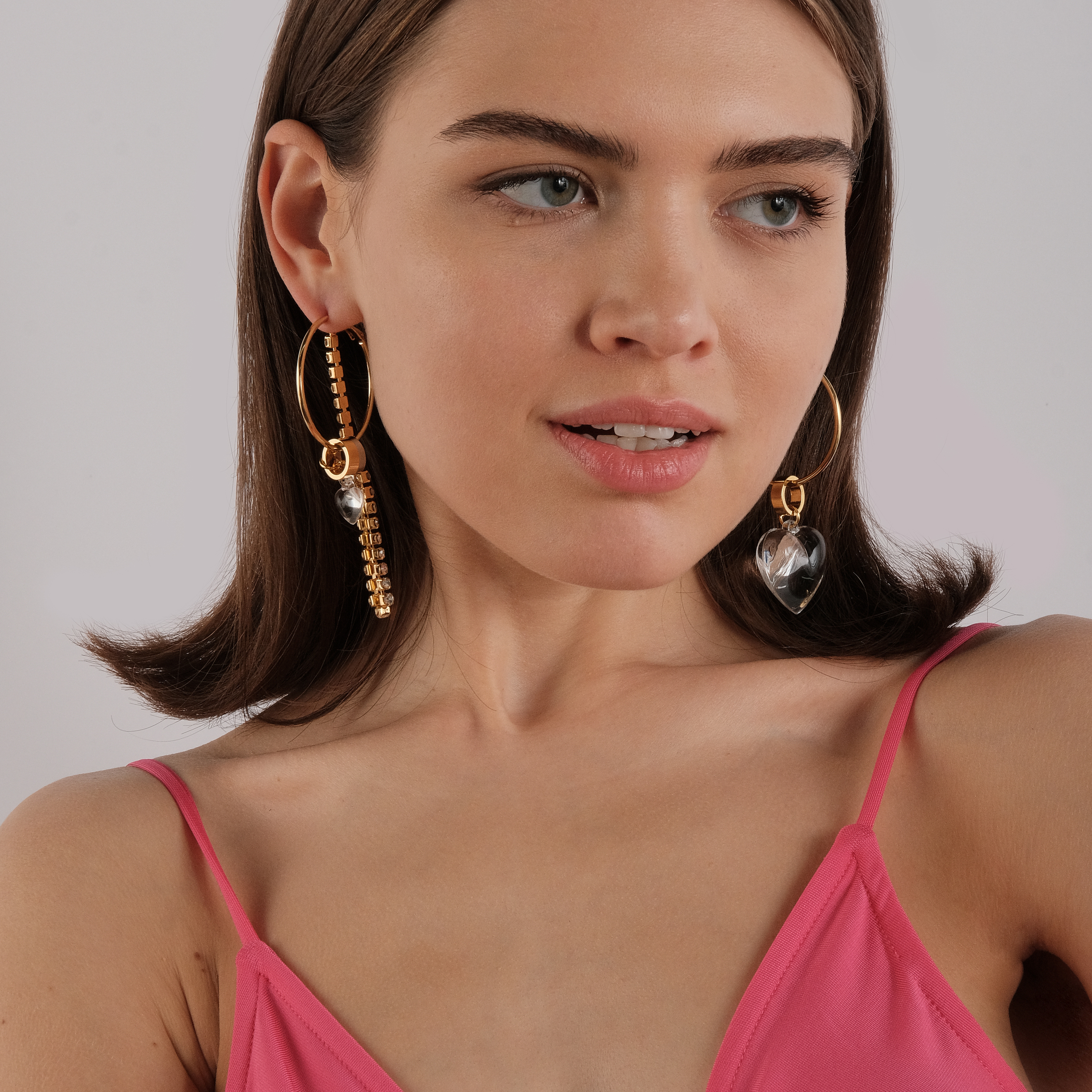asymmetric earrings with a heart and a crystal pendant