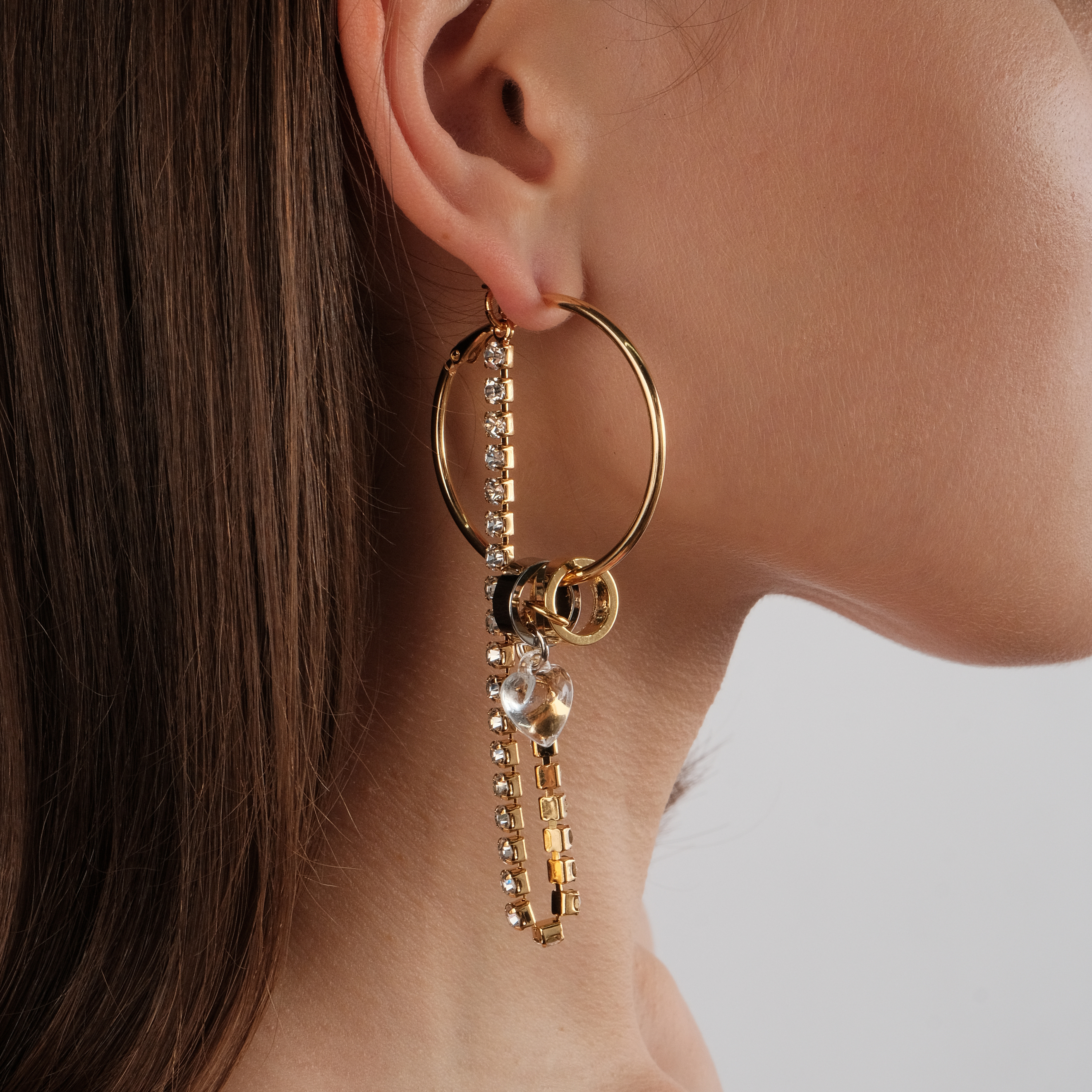 asymmetric earrings with a heart and a crystal pendant