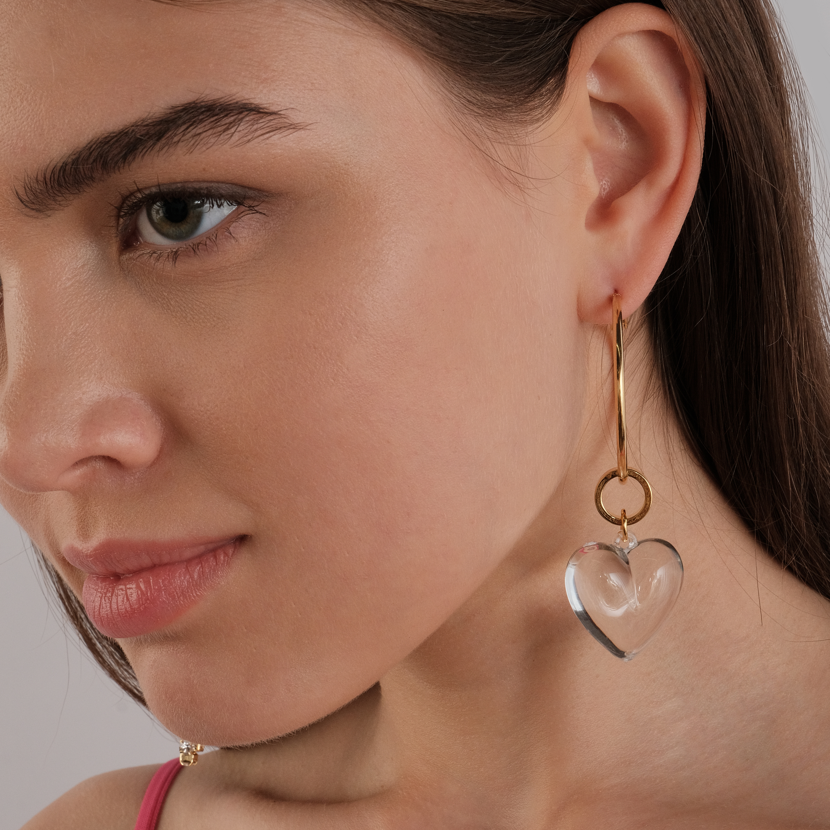 asymmetric earrings with a heart and a crystal pendant