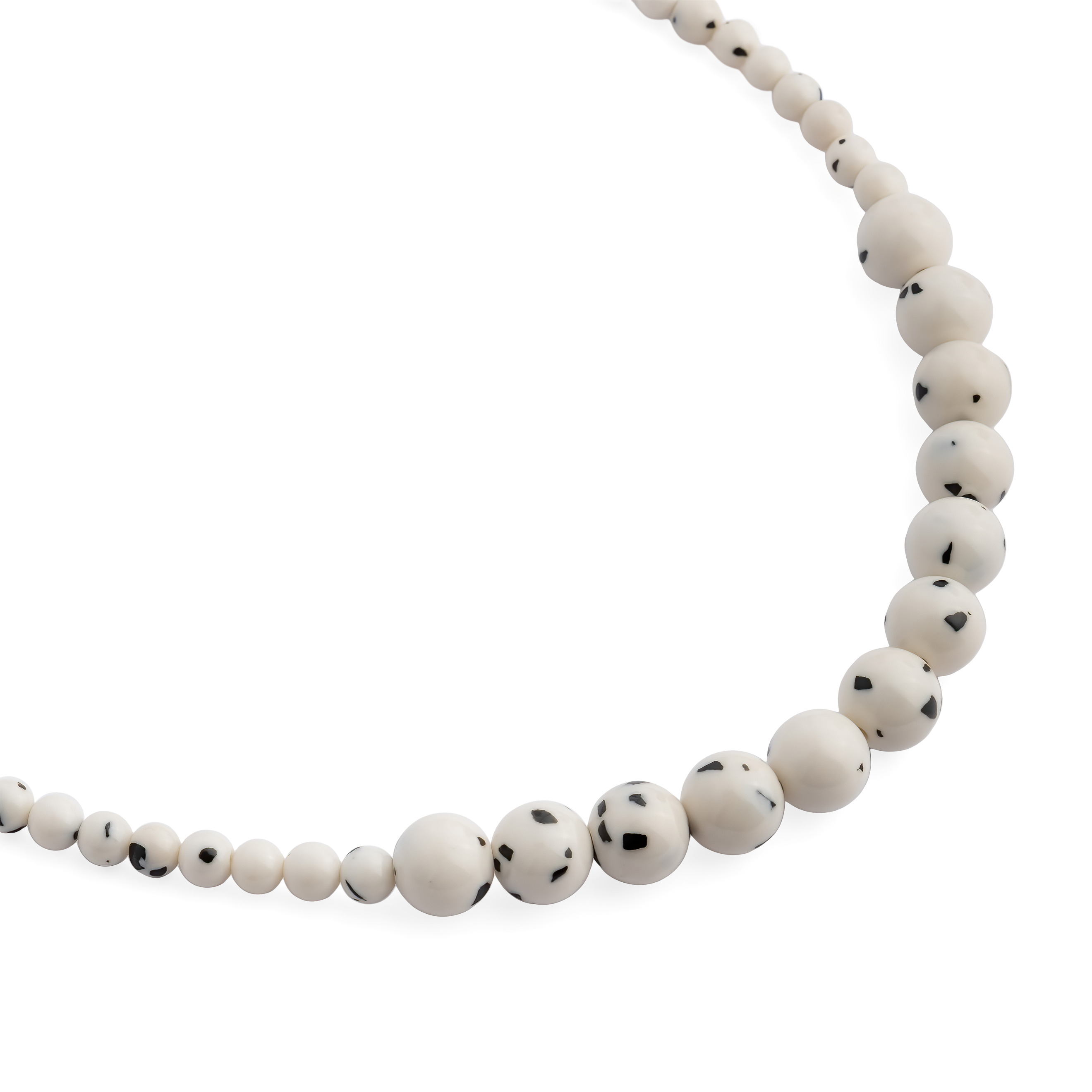 White necklace made of beads of different sizes