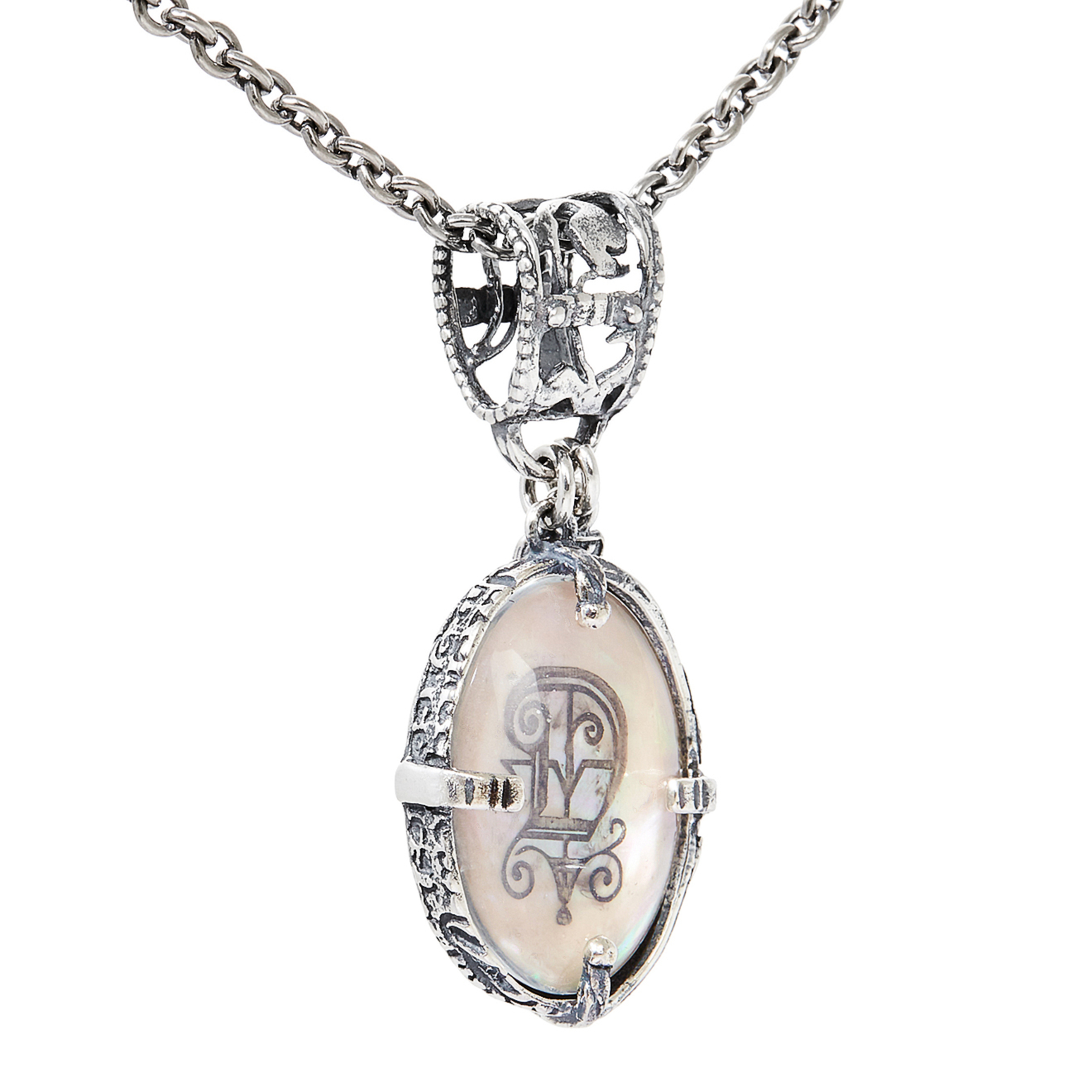 Silver medallion with the letter D