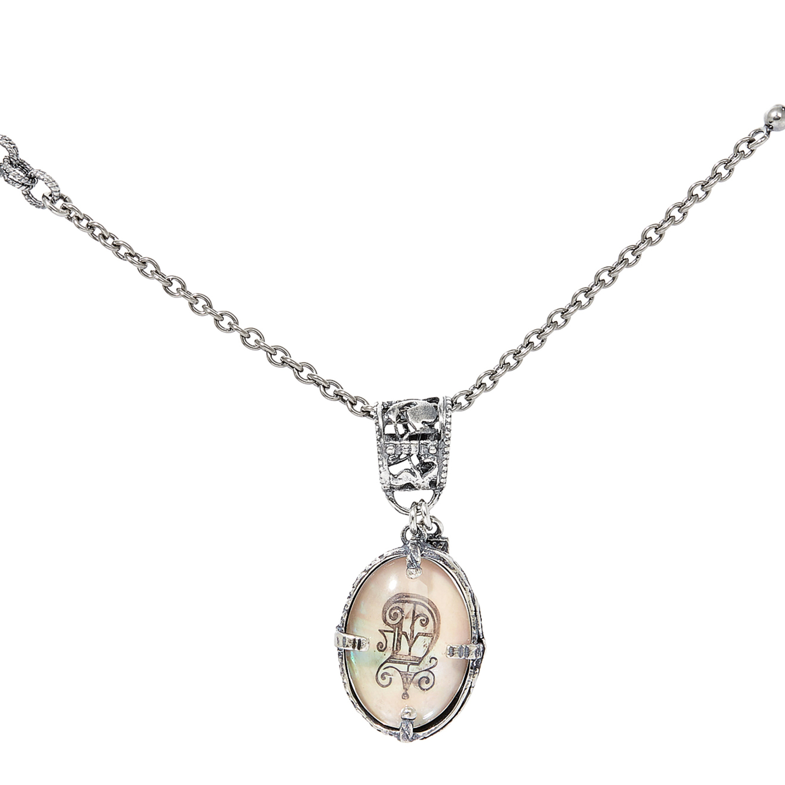 Silver medallion with the letter D