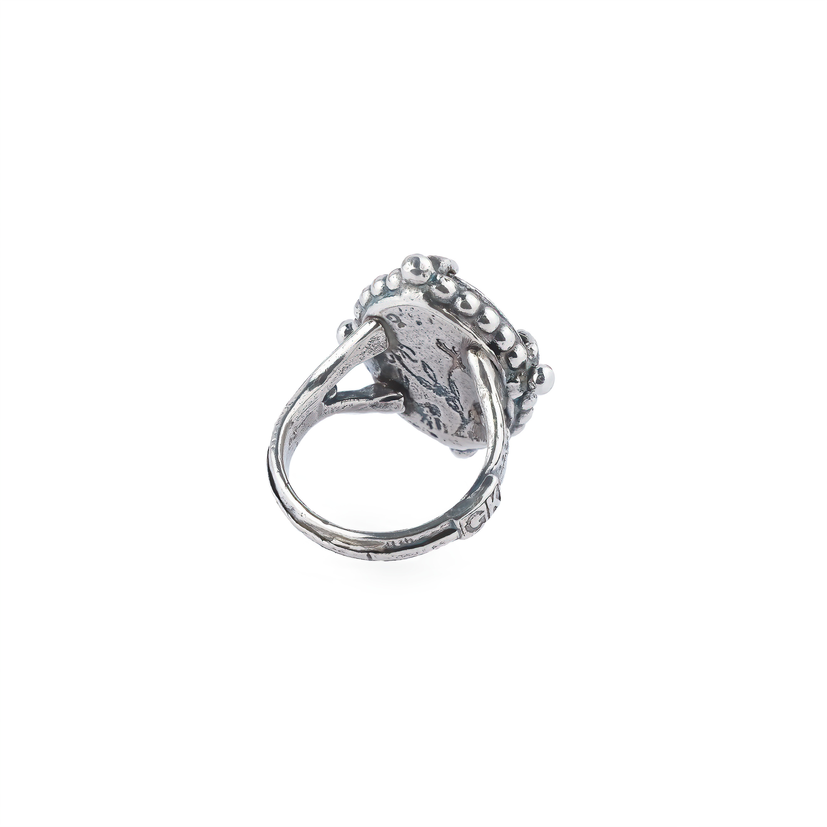 Silver ring with carved black crystal and dragon pattern