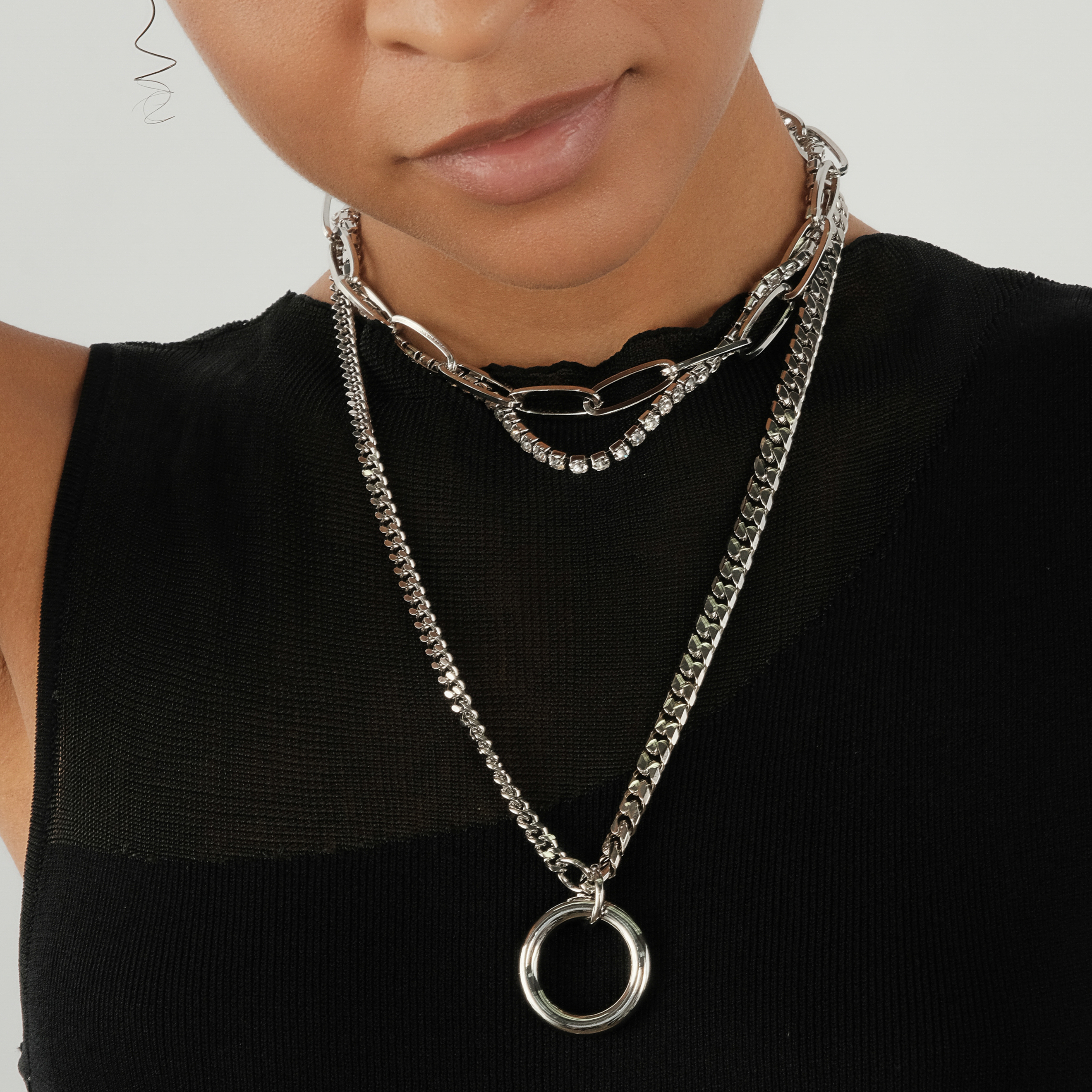 triple chain necklace with crystals and a circle pendant