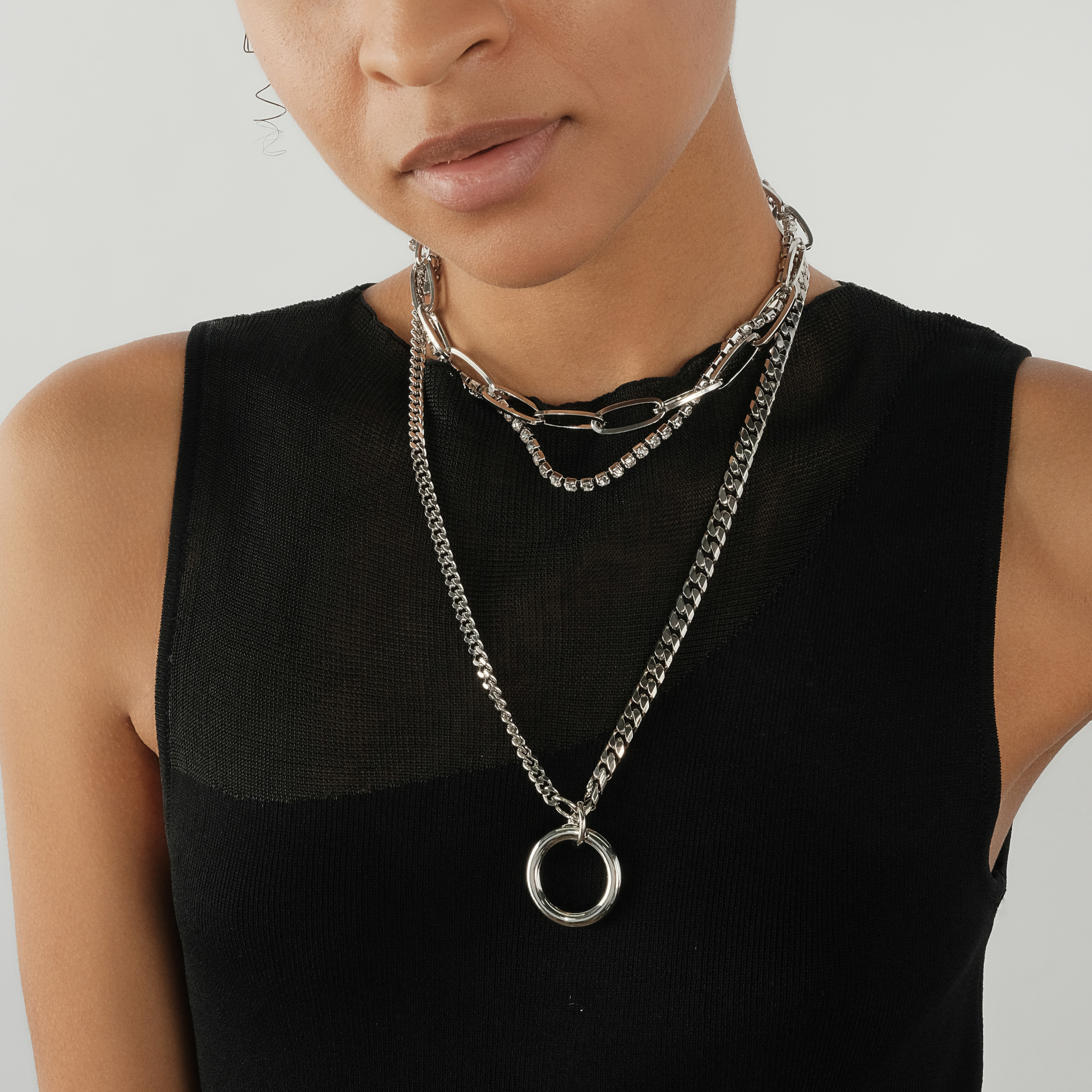 triple chain necklace with crystals and a circle pendant