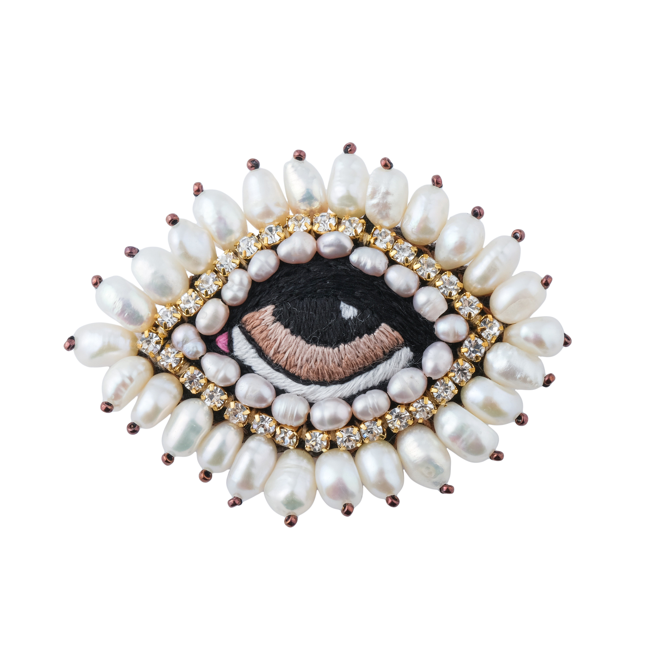 The brooch in the form of an eye is small with white pearls and a brown eye