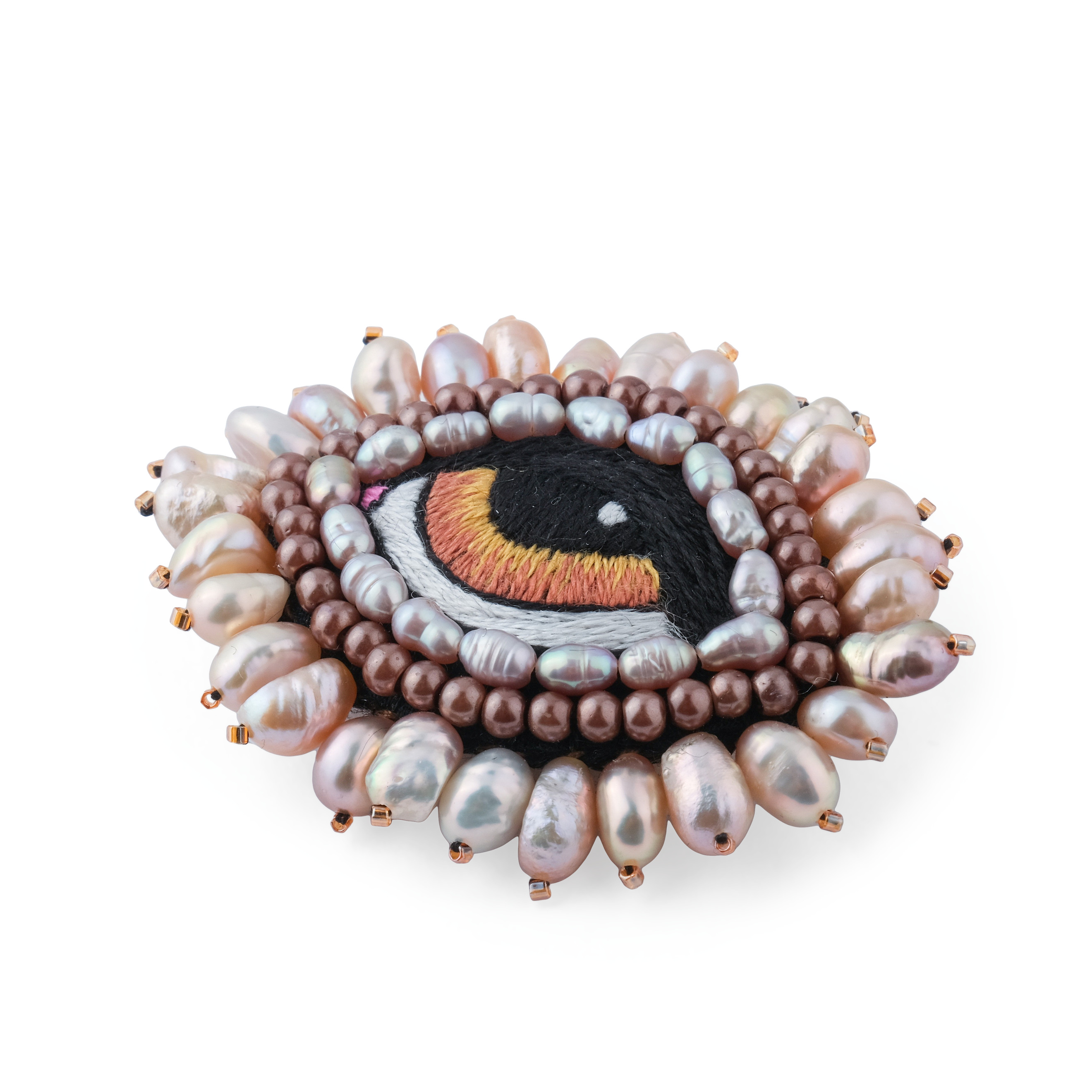 A small brooch in the form of an eye with brown pearls