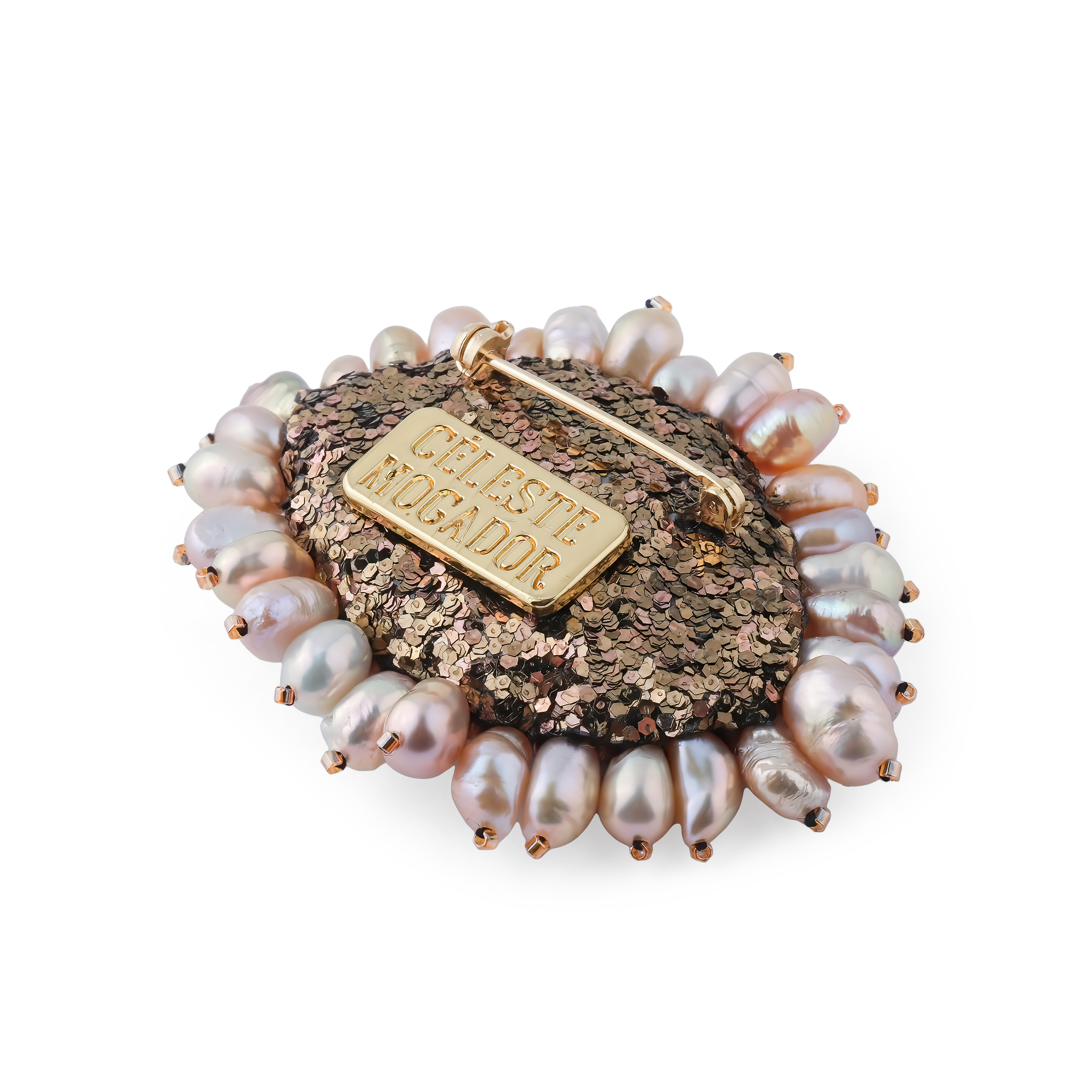A small brooch in the form of an eye with brown pearls