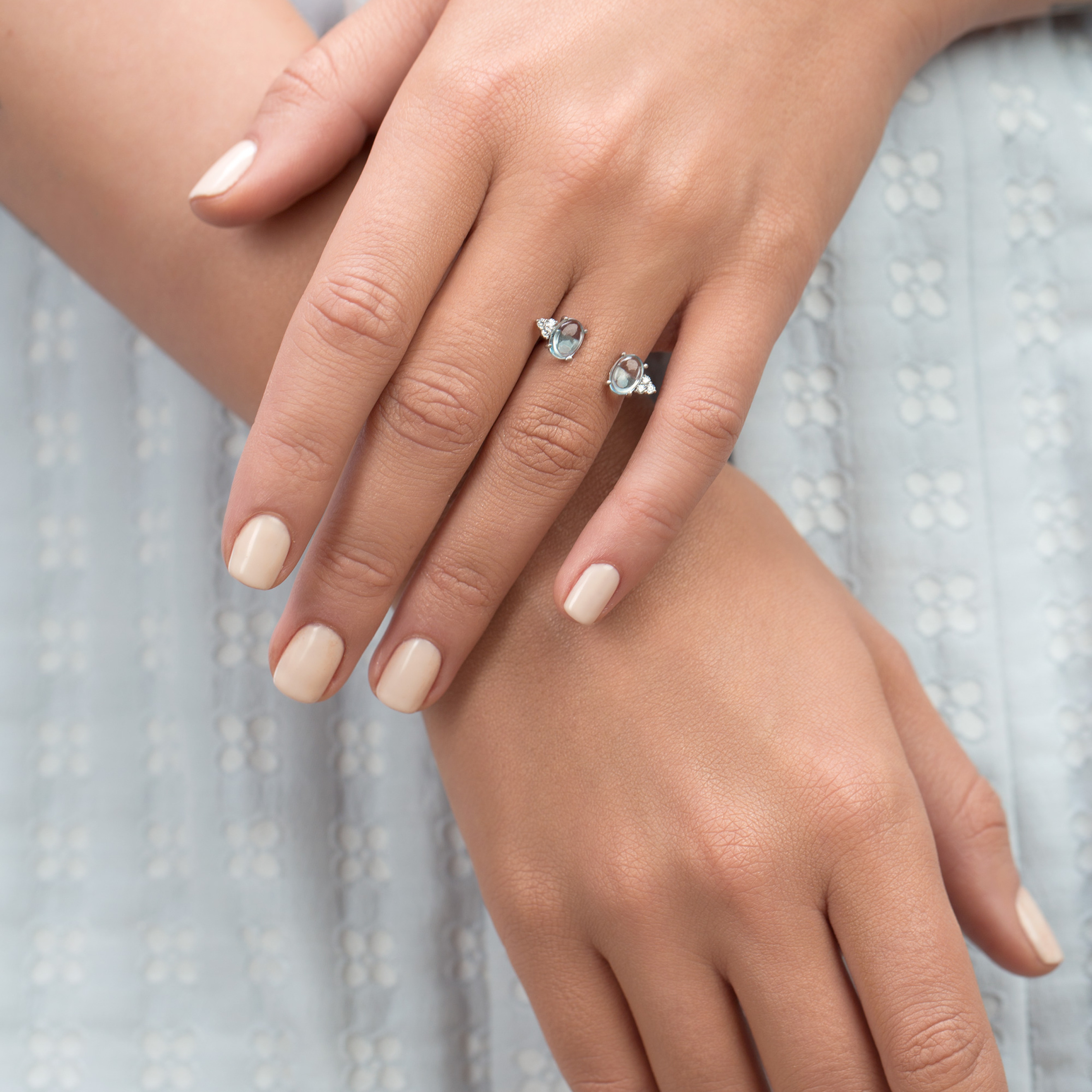 Open silver ring with blue topaz