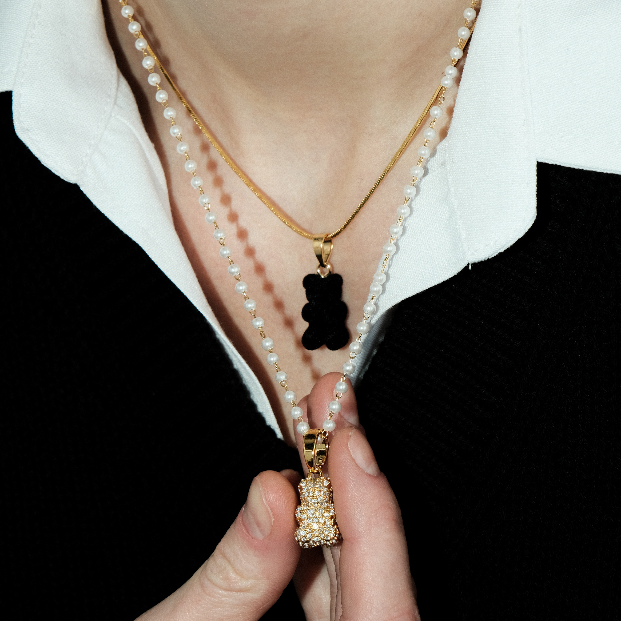 necklace with pearls and a bear pendant with crystals