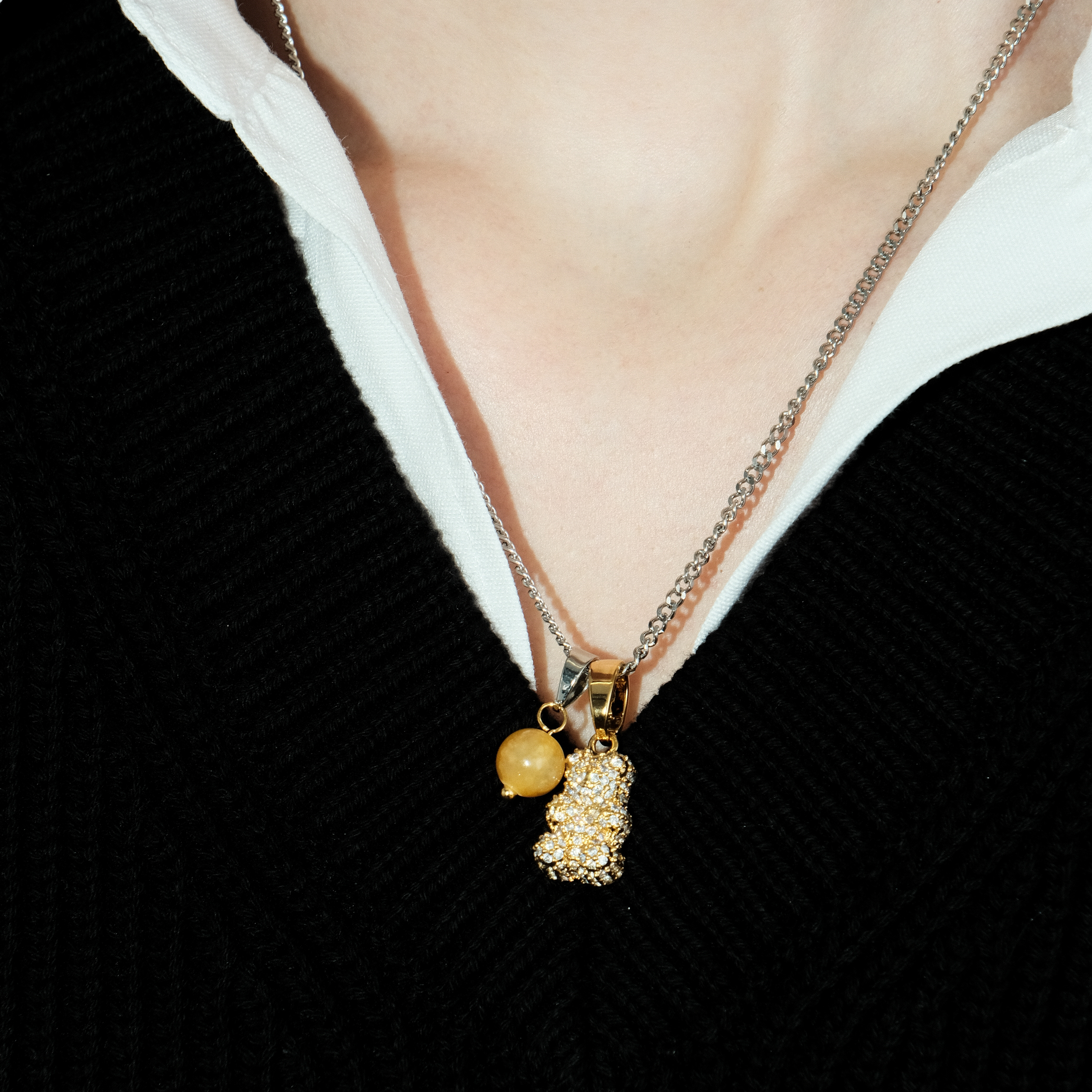 Necklace with a golden bear pendant and a yellow bead