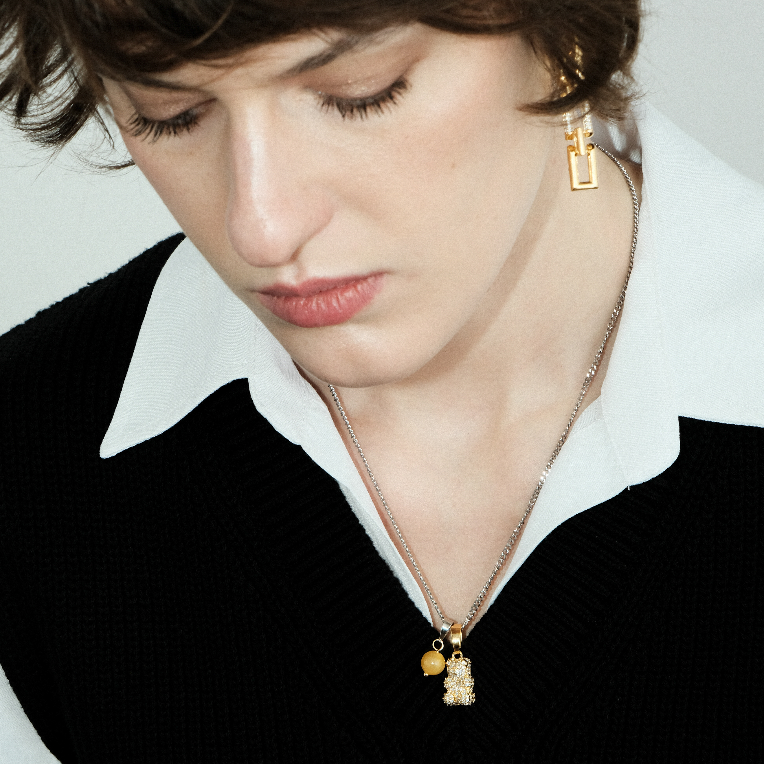 Necklace with a golden bear pendant and a yellow bead