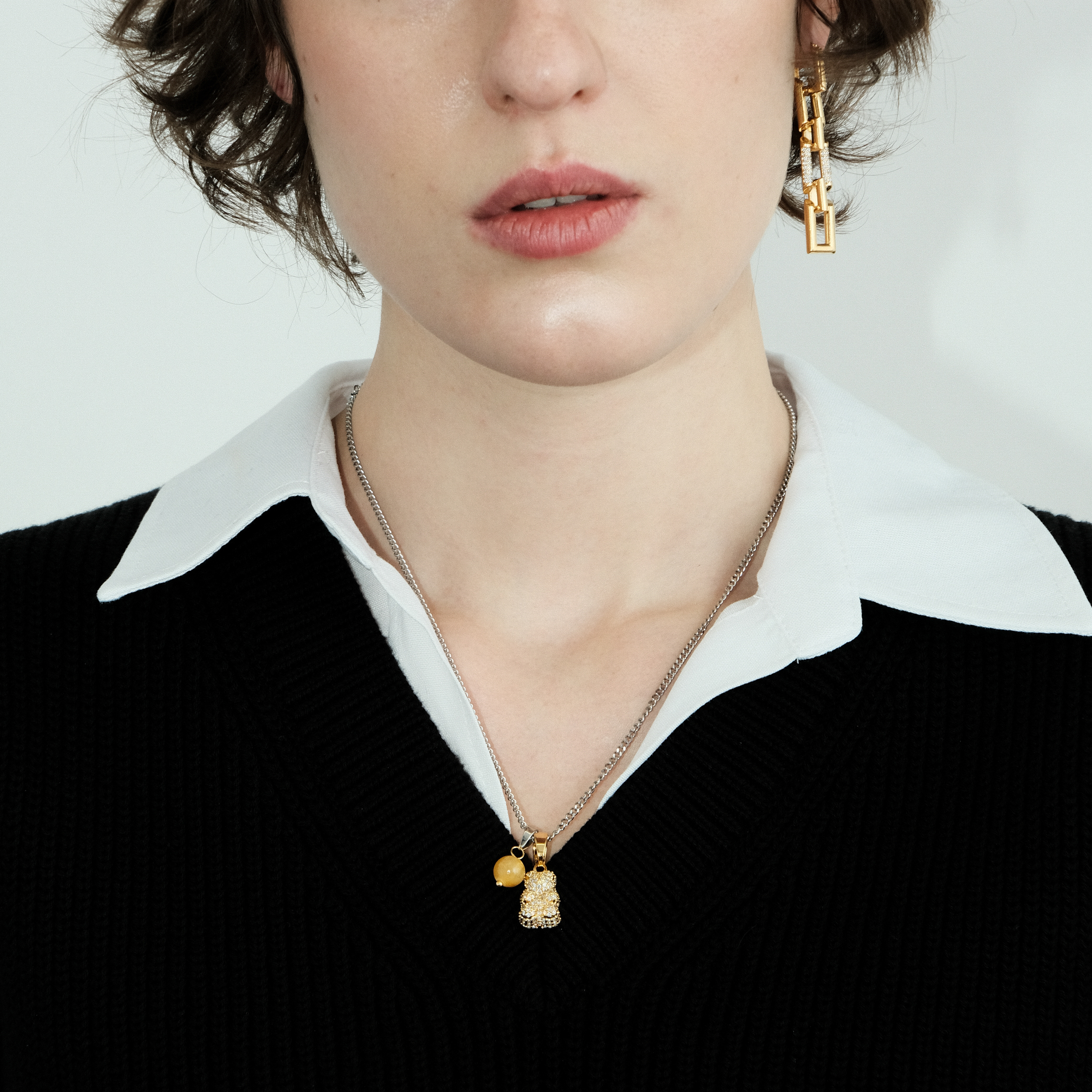 Necklace with a golden bear pendant and a yellow bead
