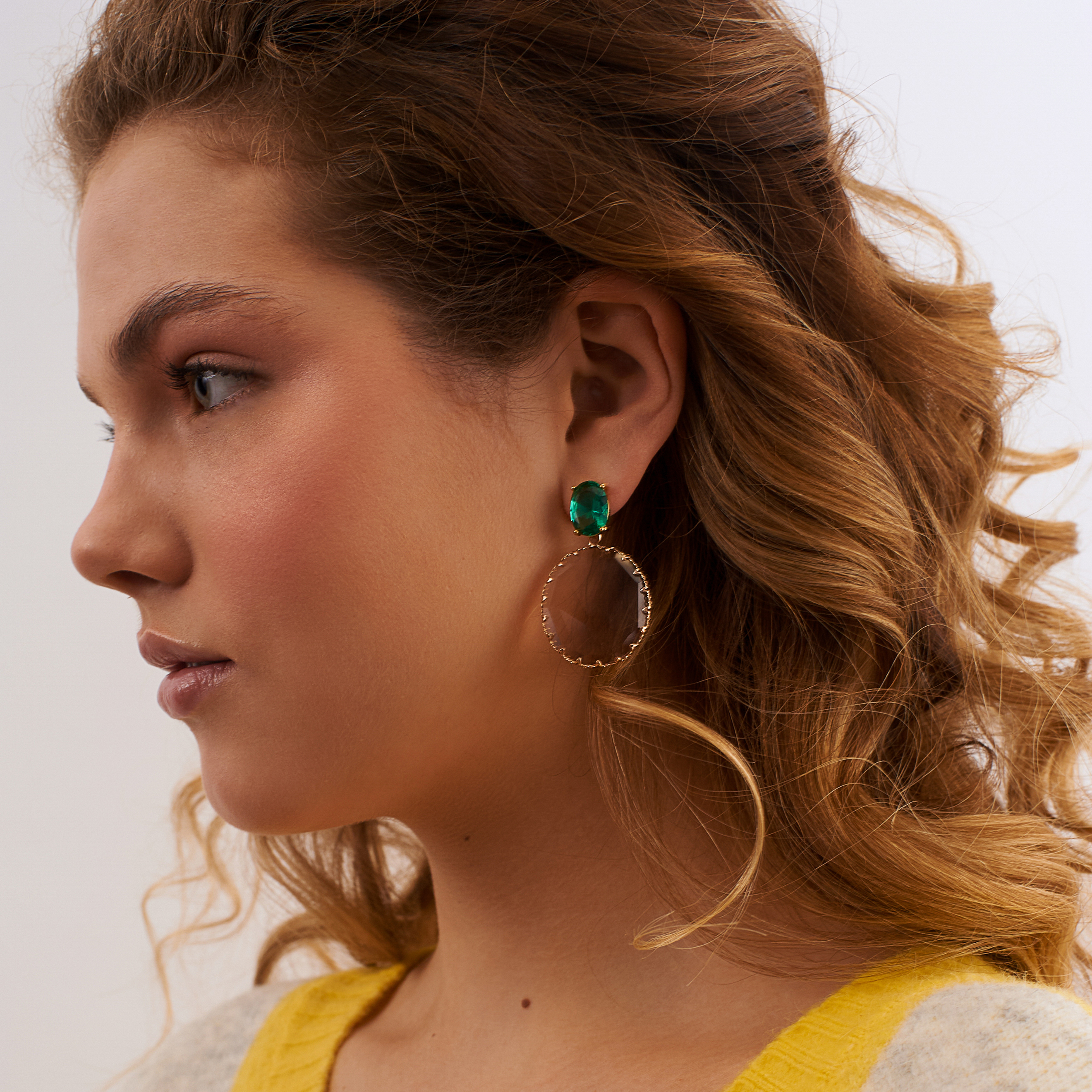 Golden earrings with large green crystals and pink oval pendants
