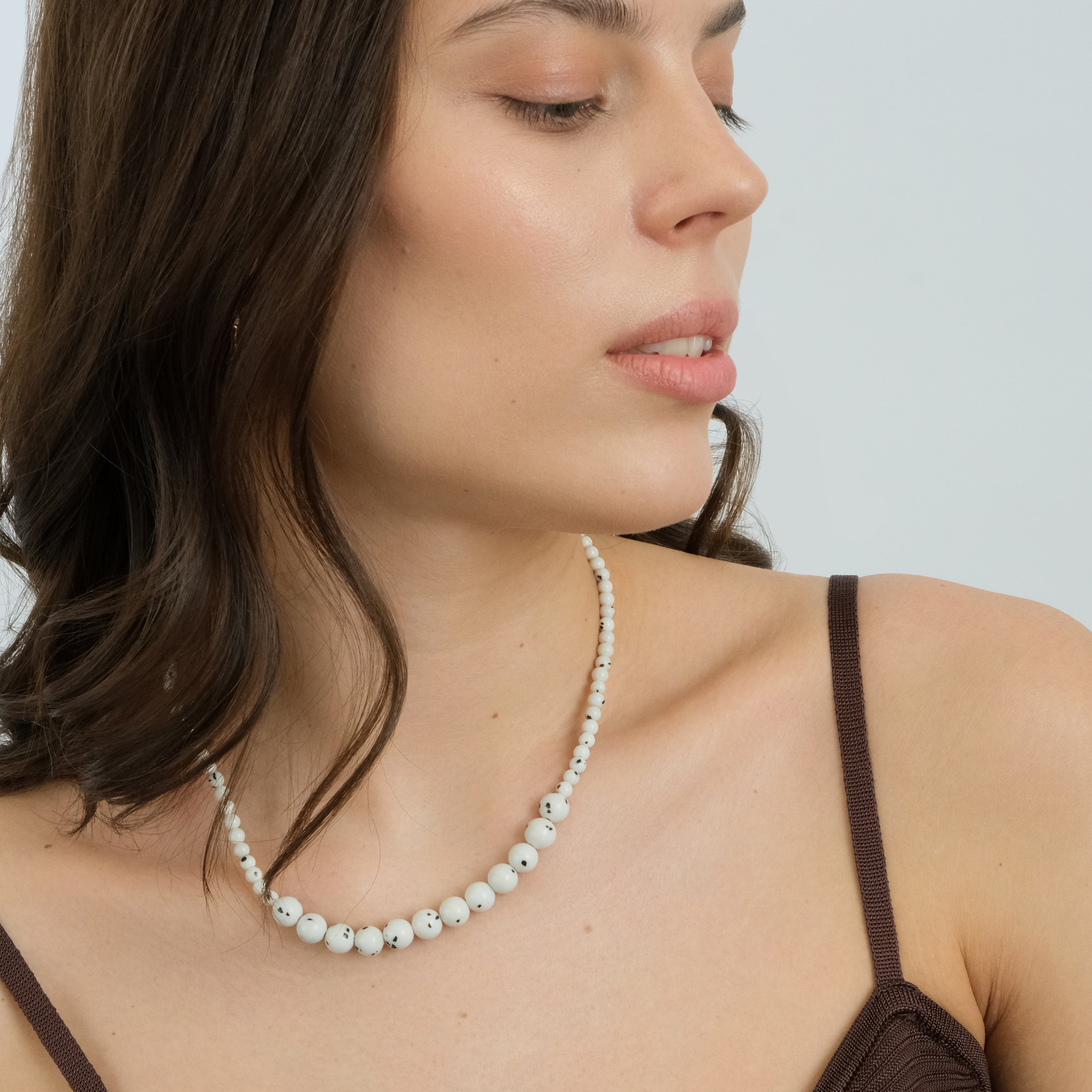 White necklace made of beads of different sizes