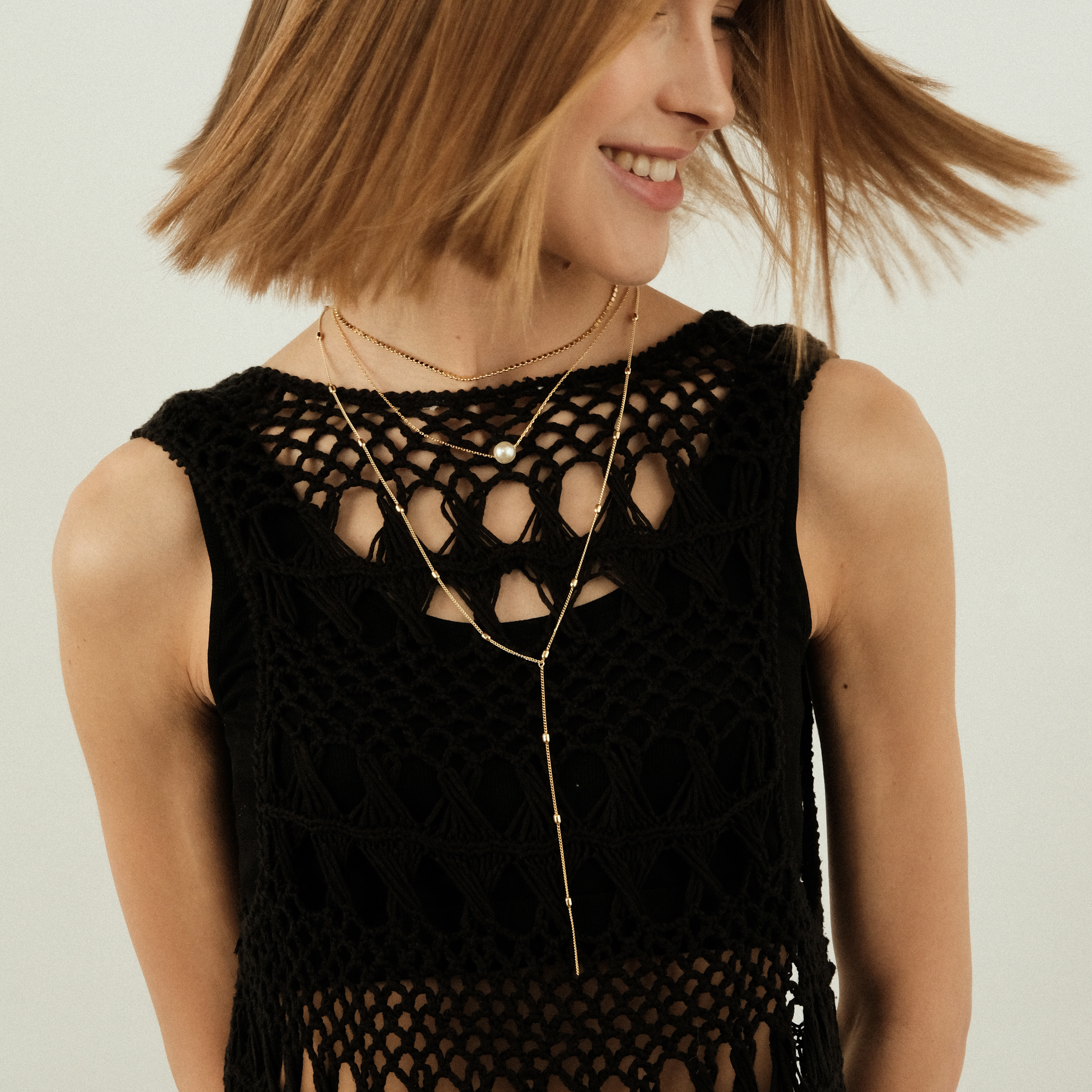 Multi-layered necklace with a white bead