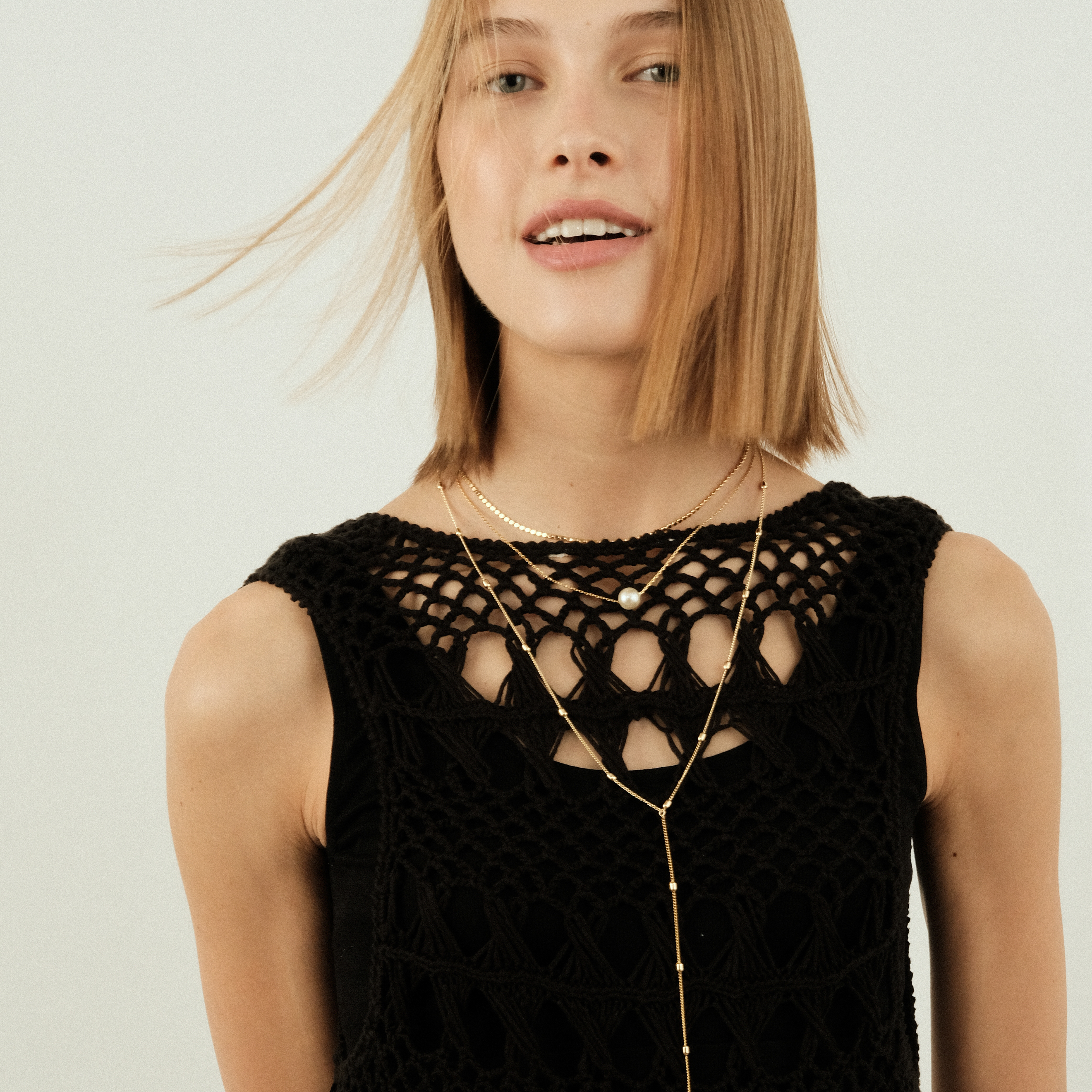 Multi-layered necklace with a white bead