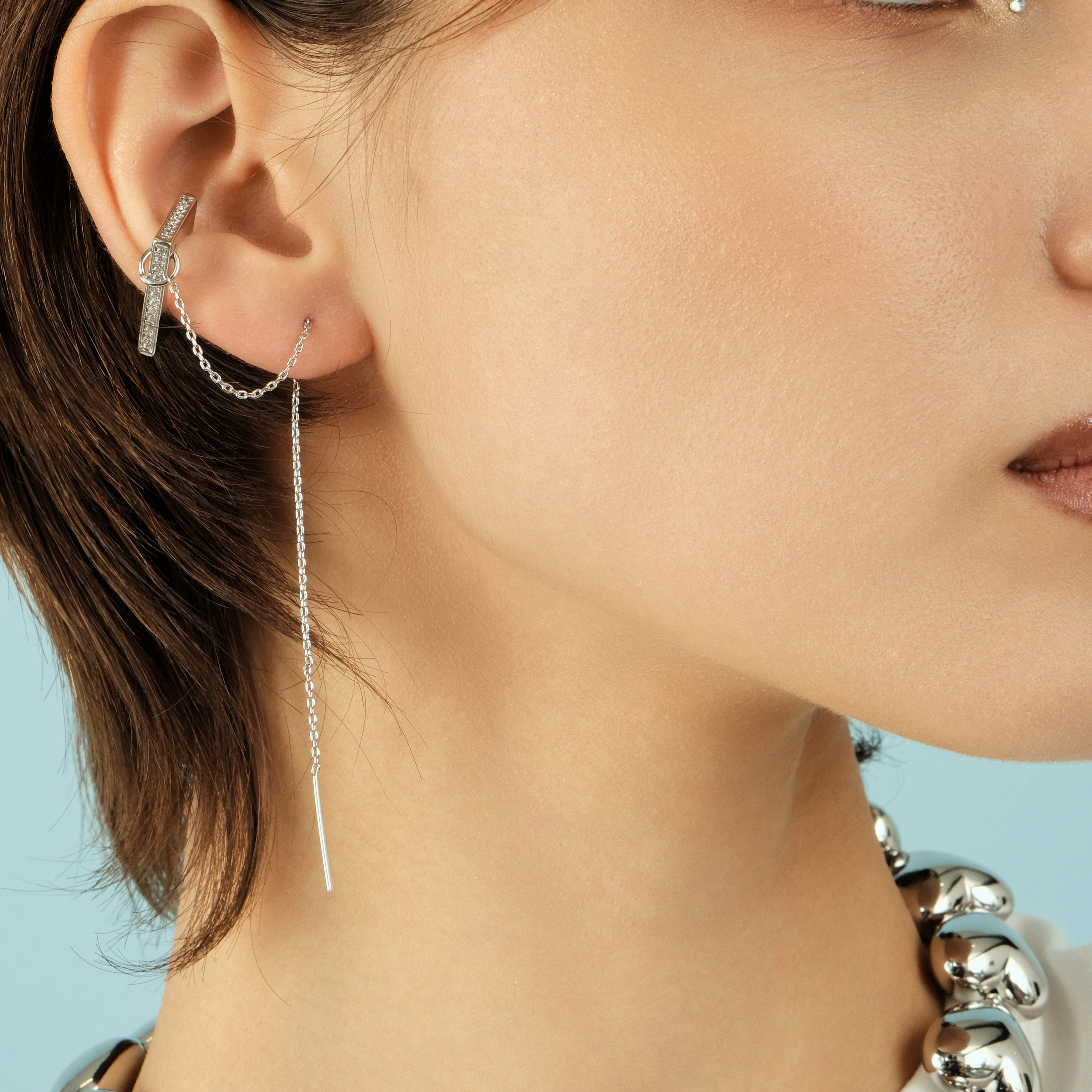 A long silver monoserge with a square cuff with a pavé of crystals