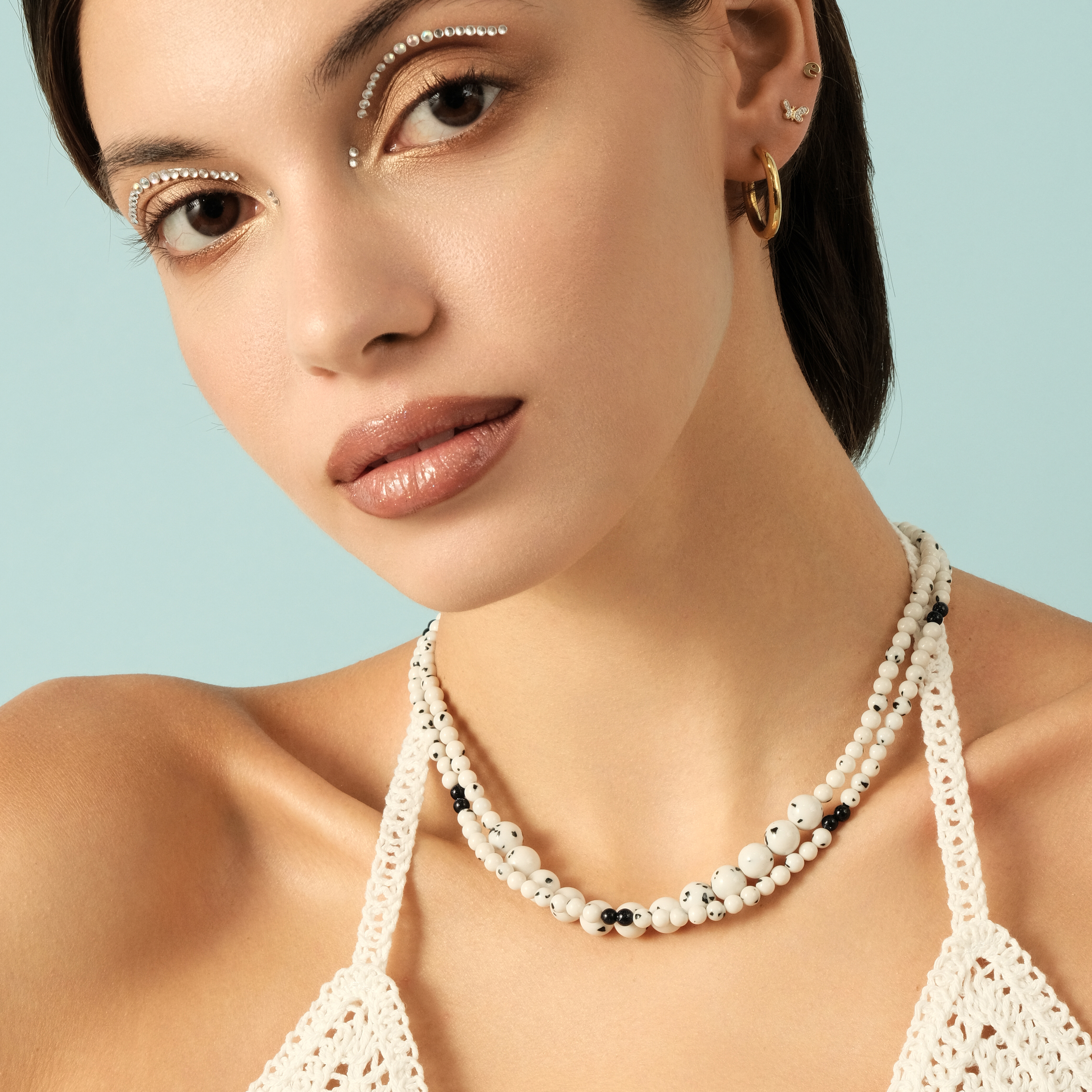 White necklace made of beads of different sizes