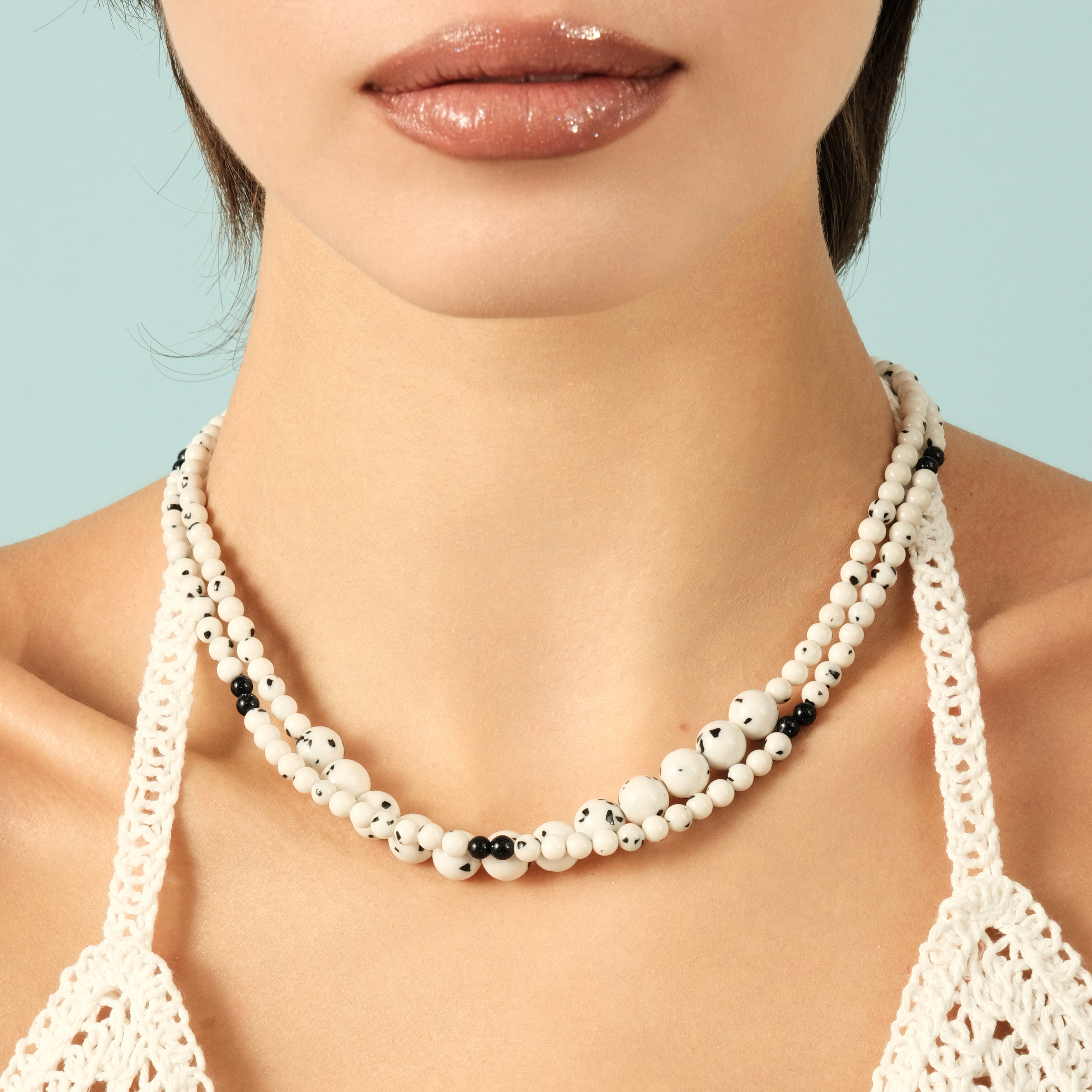 White necklace made of beads of different sizes